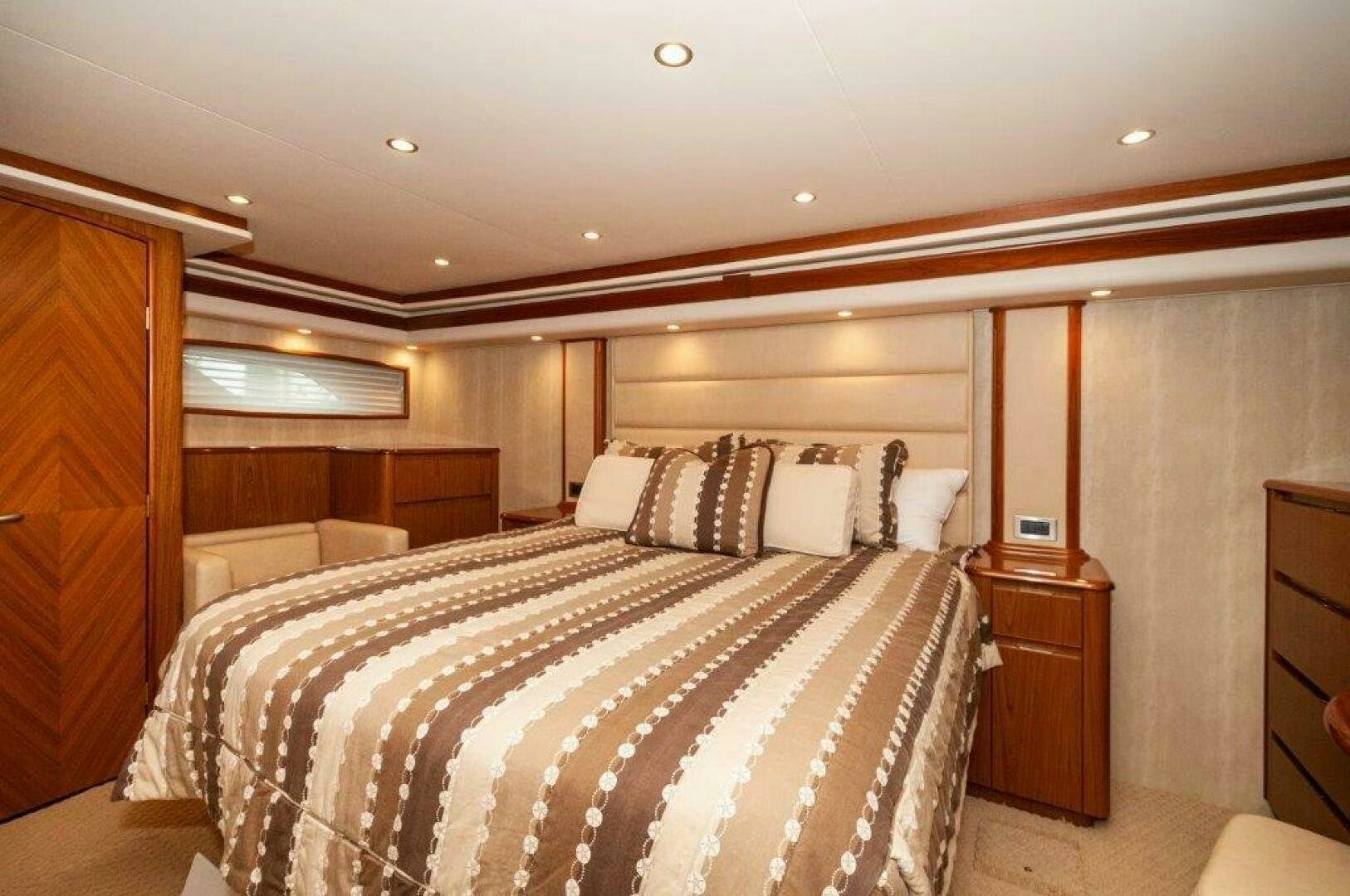 a bedroom with a bed and a couch aboard BAREFOOT DRIVE Yacht for Sale