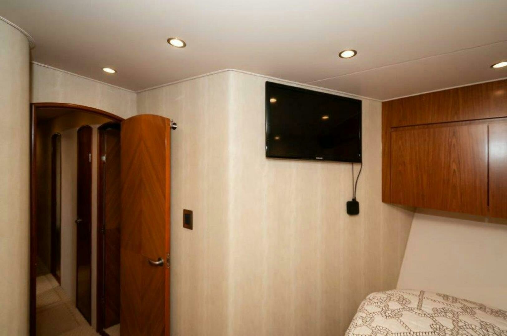 a room with a tv and a bed aboard BAREFOOT DRIVE Yacht for Sale