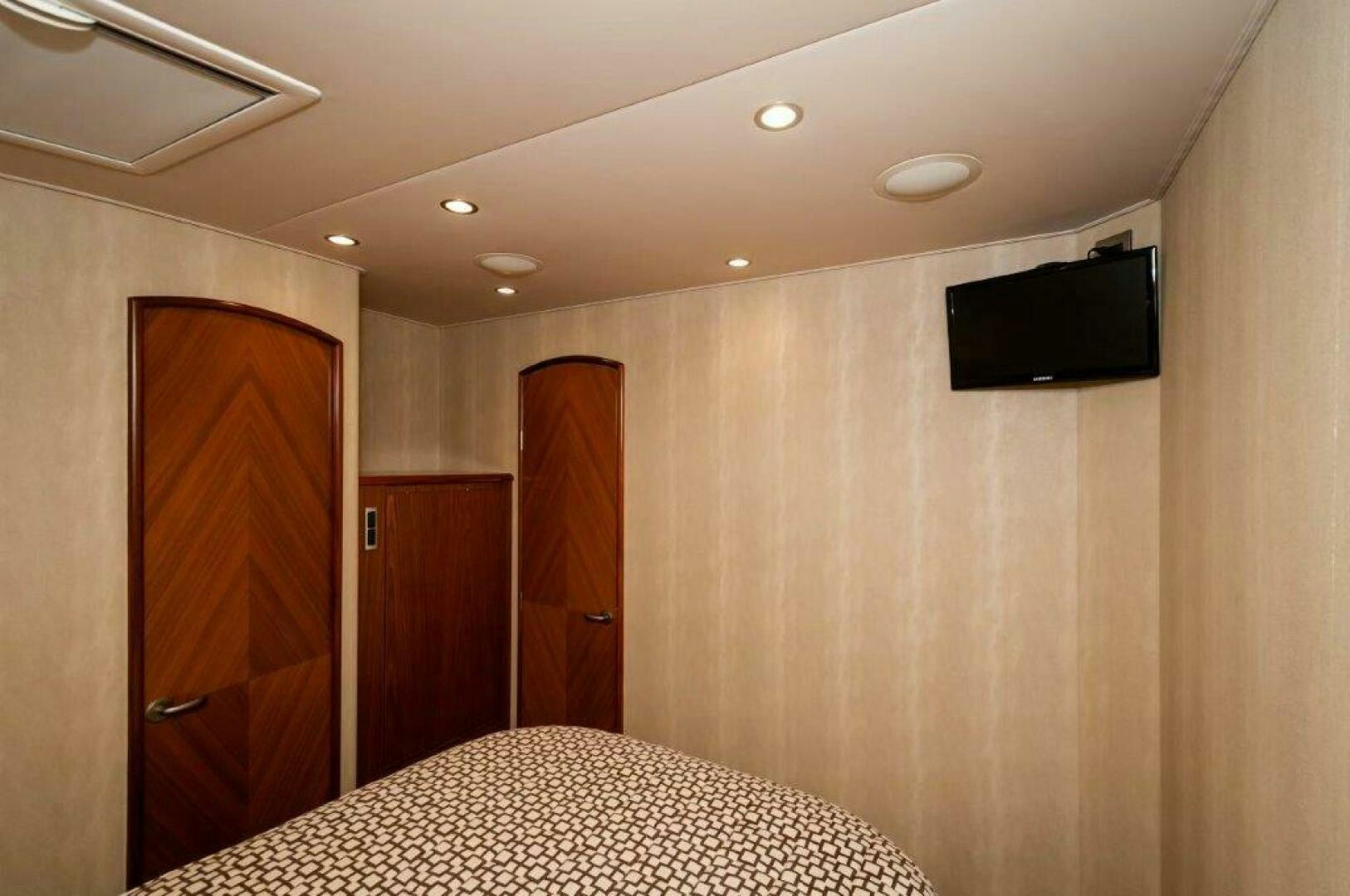 a hotel room with a tv on the wall aboard BAREFOOT DRIVE Yacht for Sale