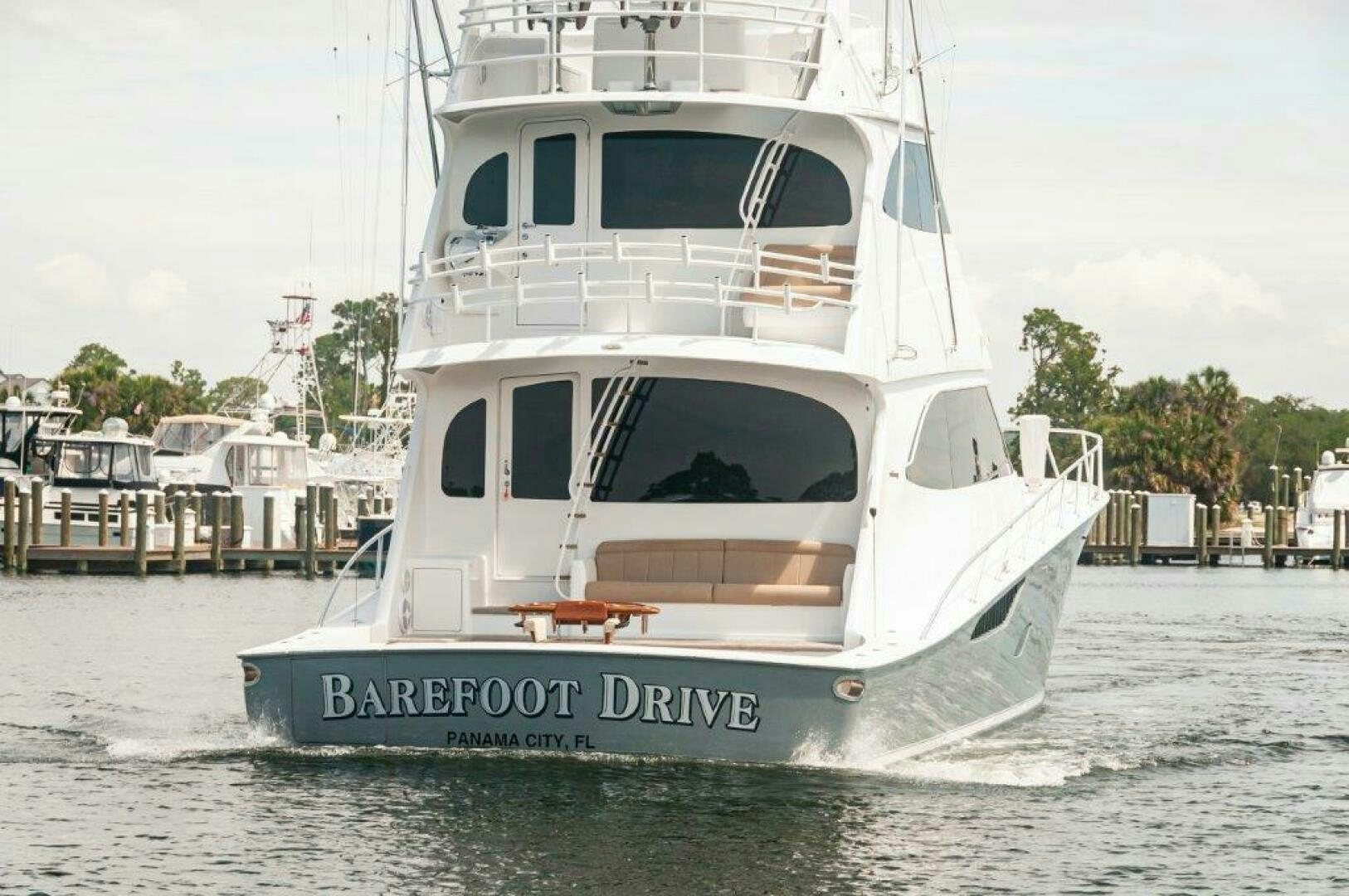 a white boat in a harbor aboard BAREFOOT DRIVE Yacht for Sale