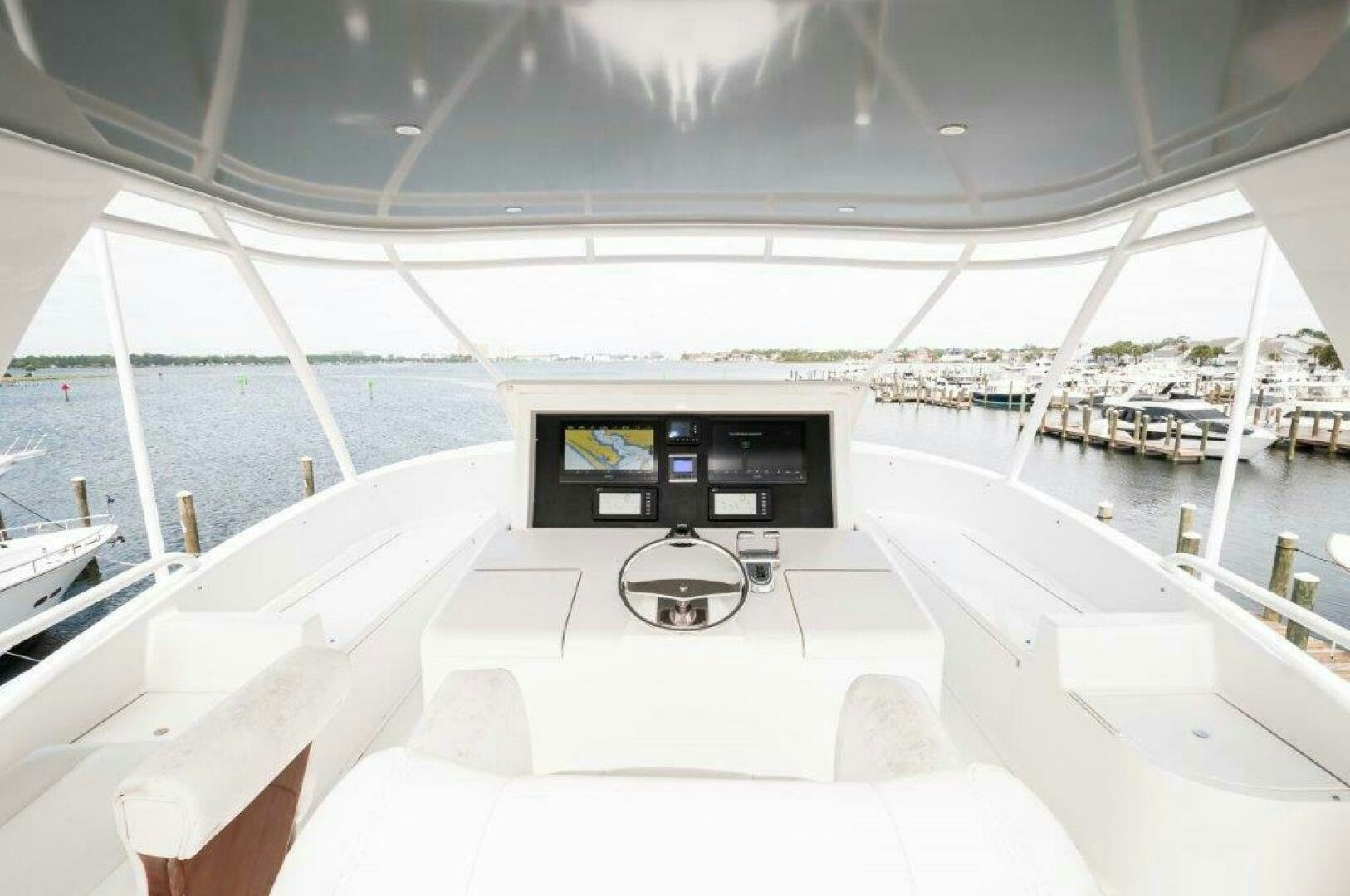 a room with a large white roof and a large window with a view of the water and boats aboard BAREFOOT DRIVE Yacht for Sale