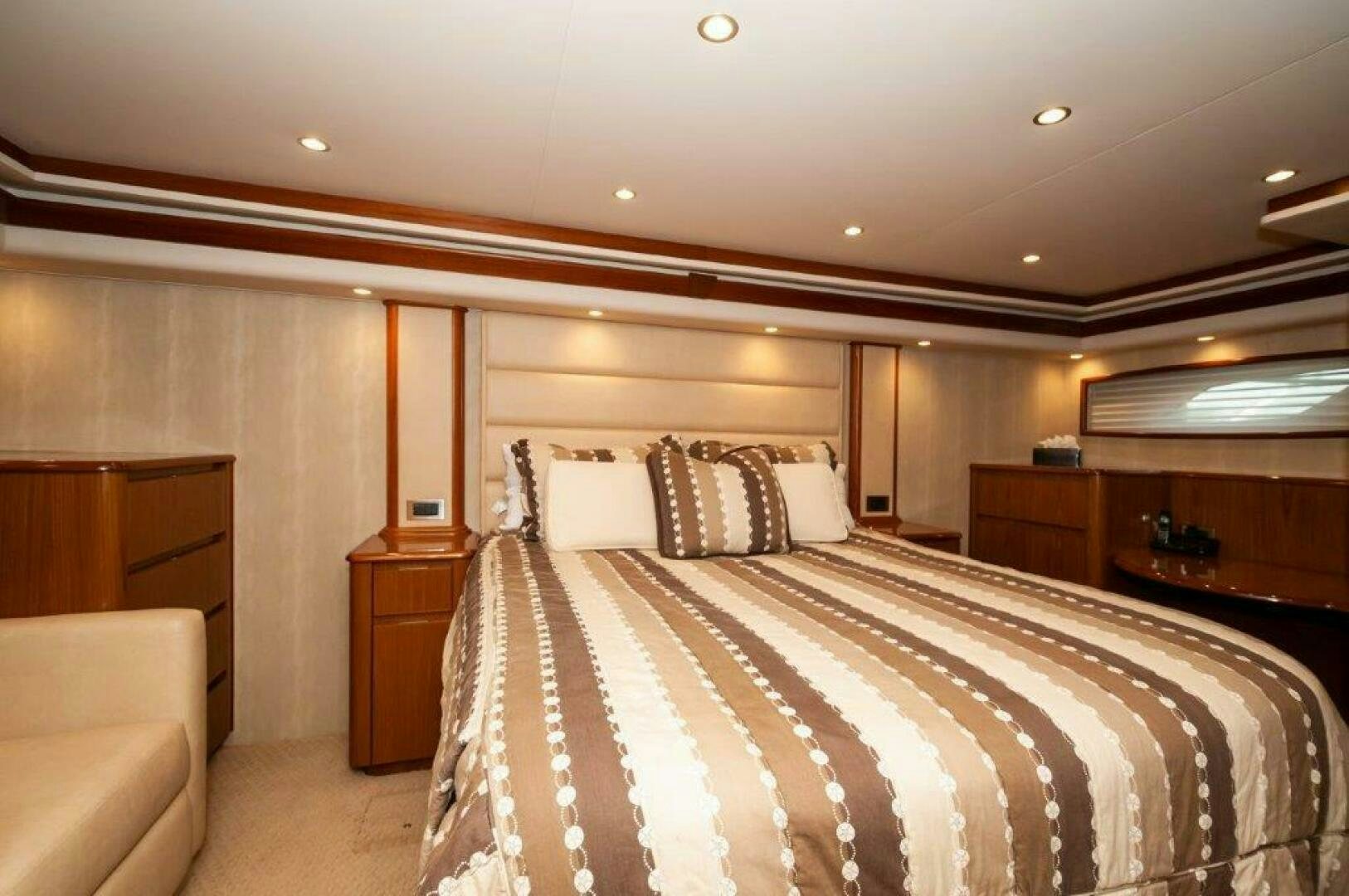 a bedroom with a bed and a chair aboard BAREFOOT DRIVE Yacht for Sale