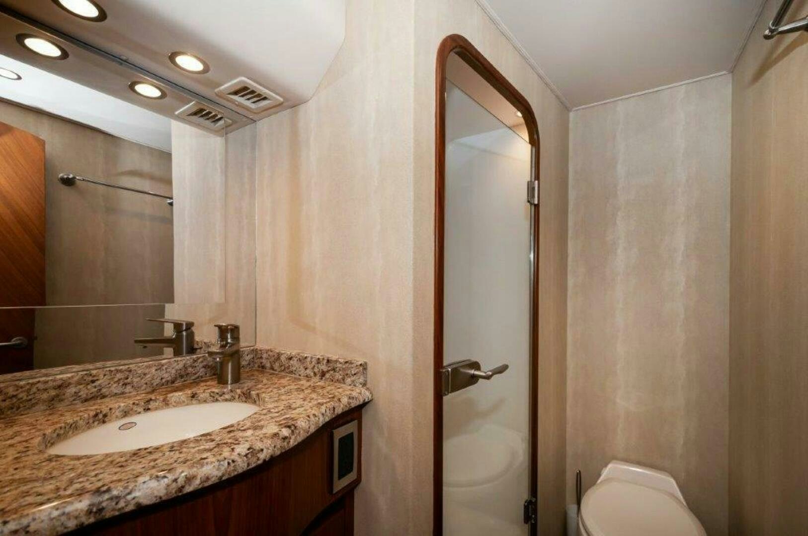 a bathroom with a large mirror aboard BAREFOOT DRIVE Yacht for Sale