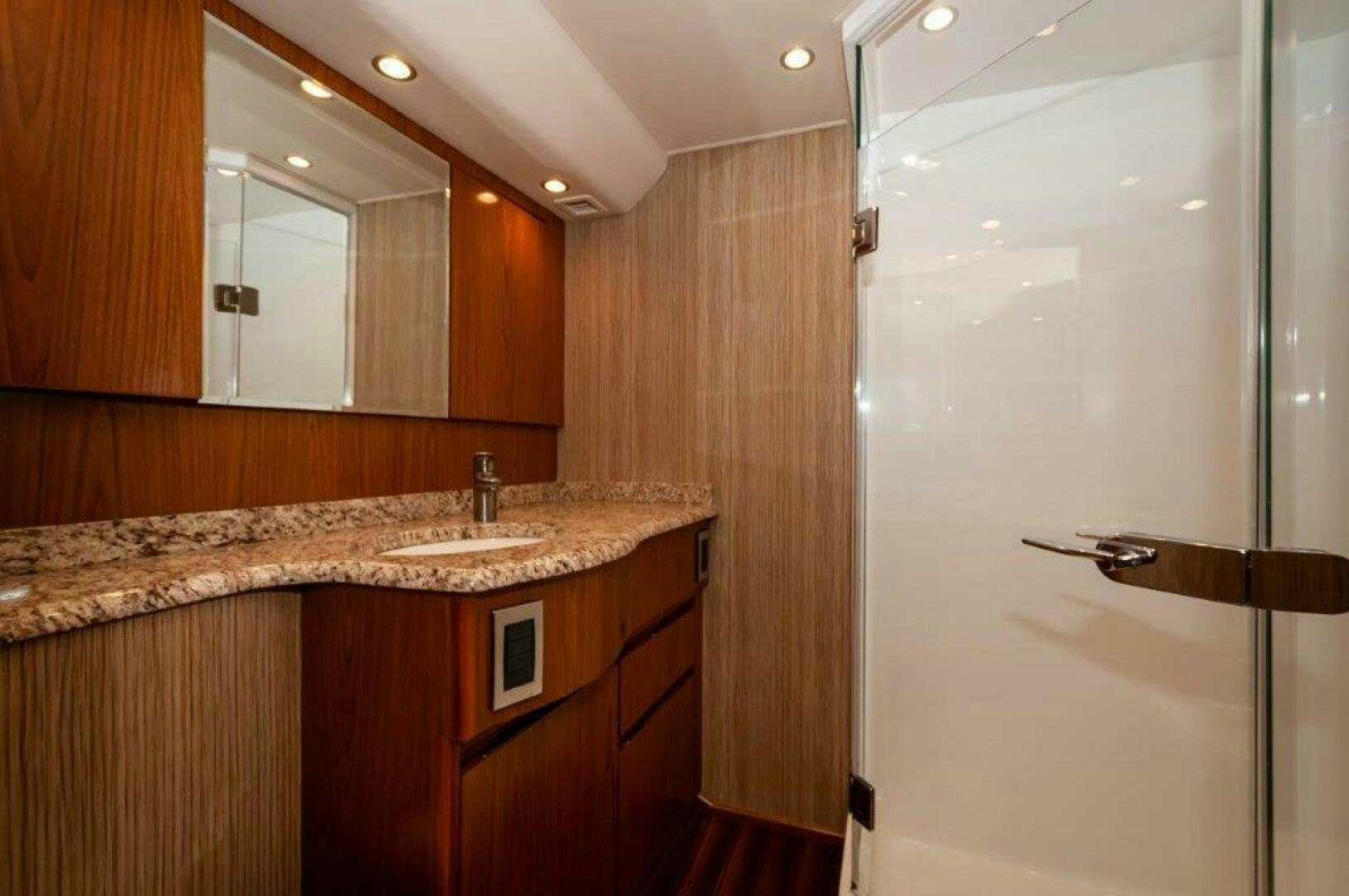 a bathroom with a countertop sink and mirror aboard BAREFOOT DRIVE Yacht for Sale