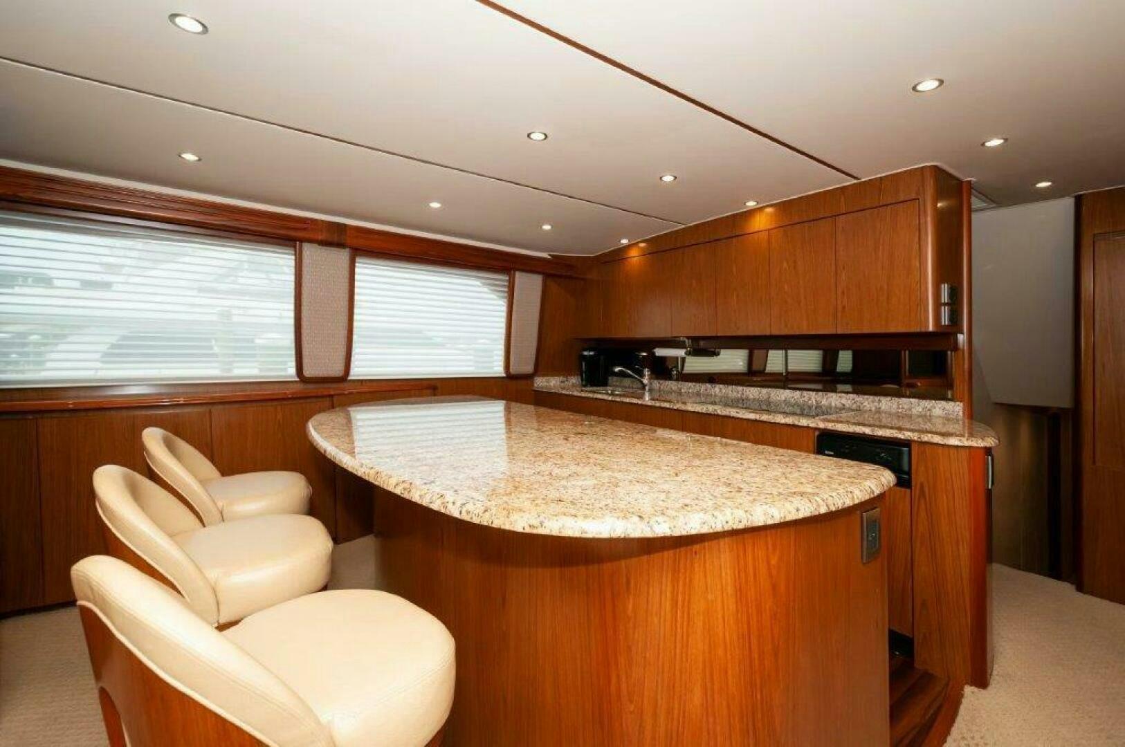a kitchen with a bar and a couch aboard BAREFOOT DRIVE Yacht for Sale
