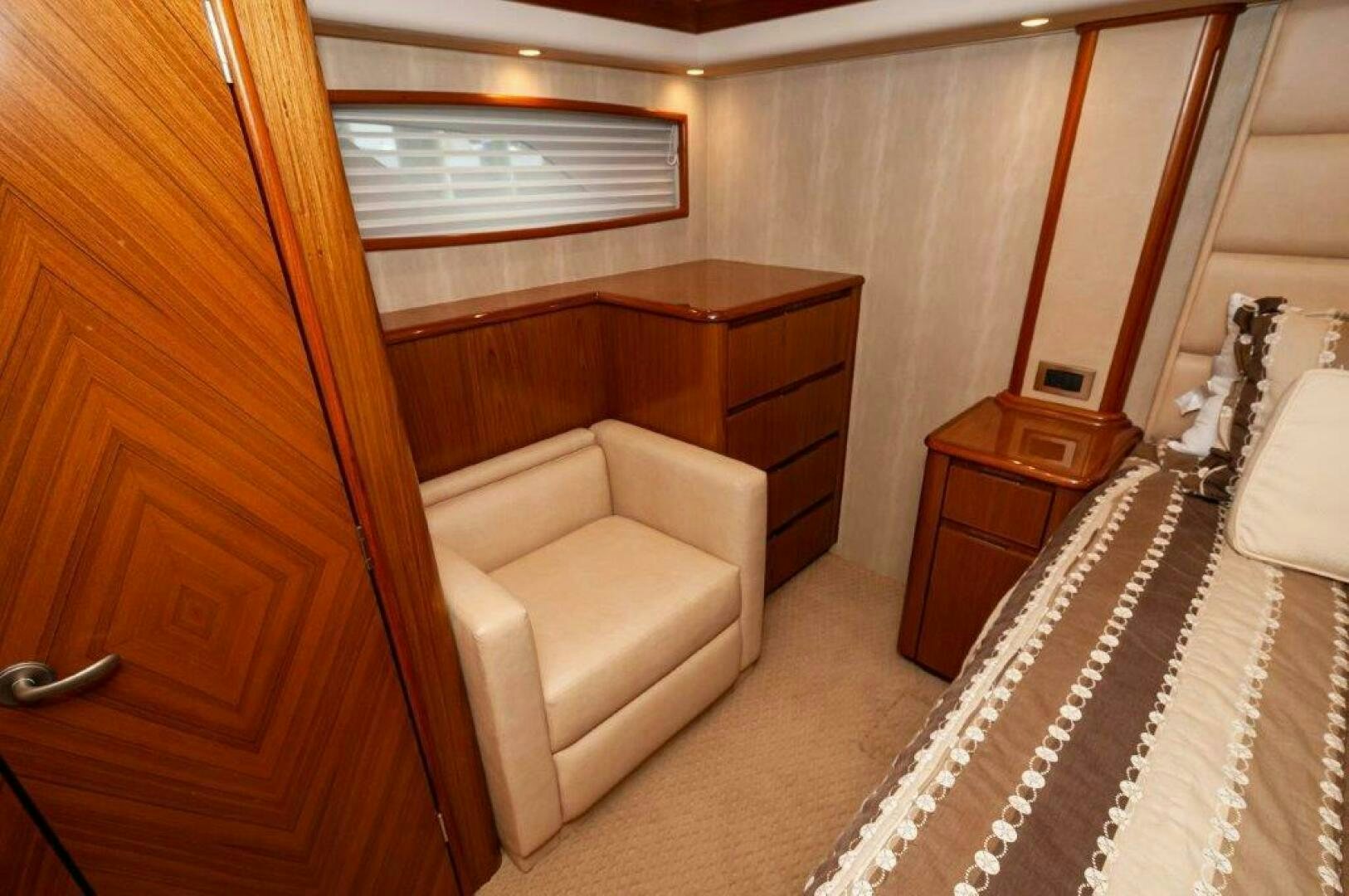 a room with a bed and a dresser aboard BAREFOOT DRIVE Yacht for Sale