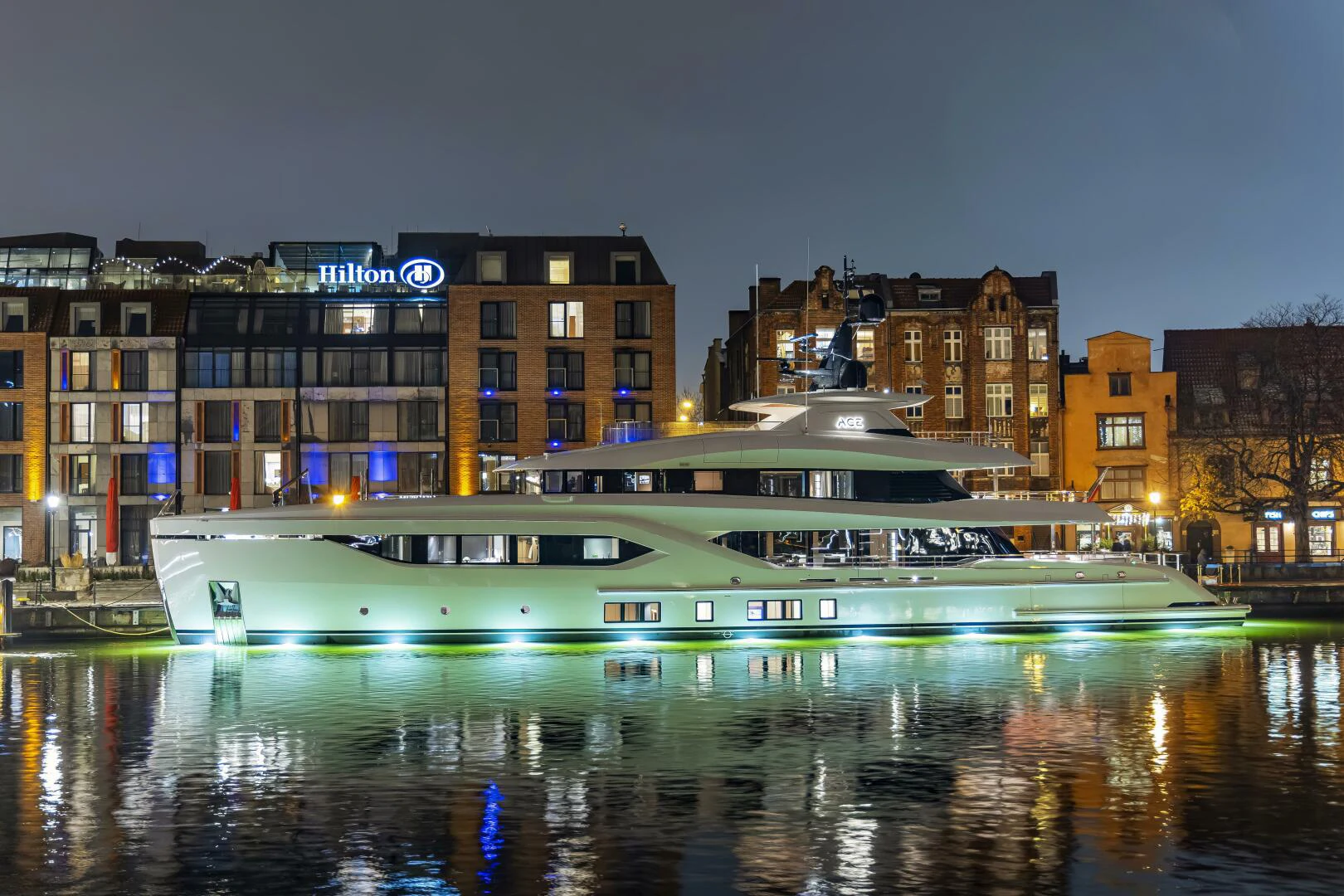 a building with lights on at night aboard CONRAD C144S HULL 4 Yacht for Sale