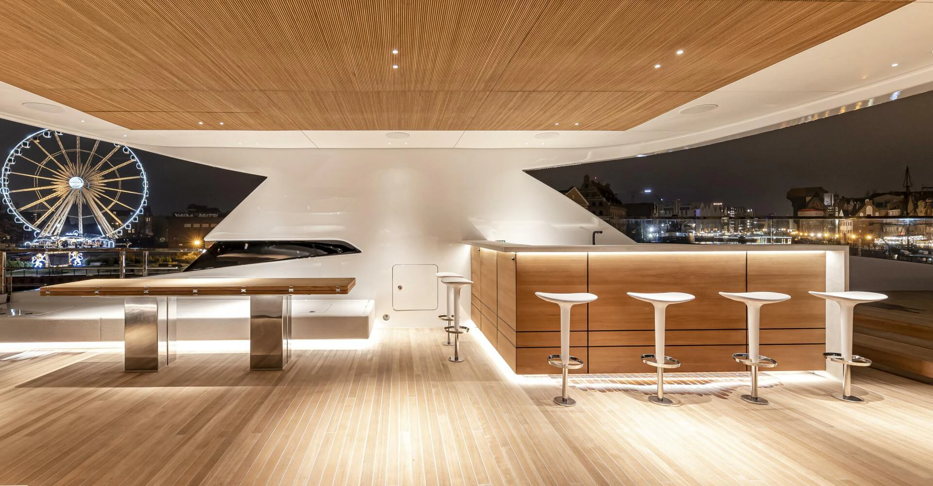 a room with tables and stools aboard CONRAD C144S HULL 4 Yacht for Sale