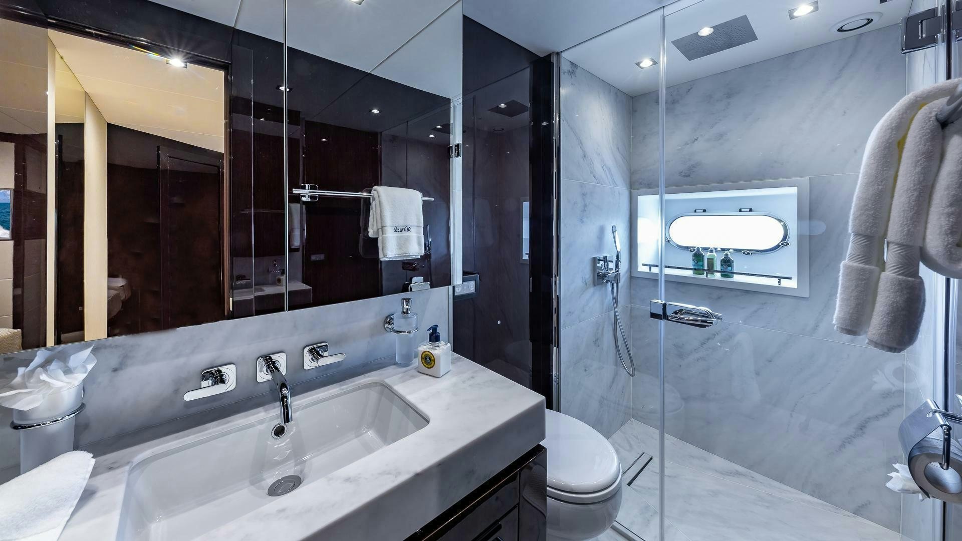 a bathroom with a large mirror aboard MIRRACLE Yacht for Sale