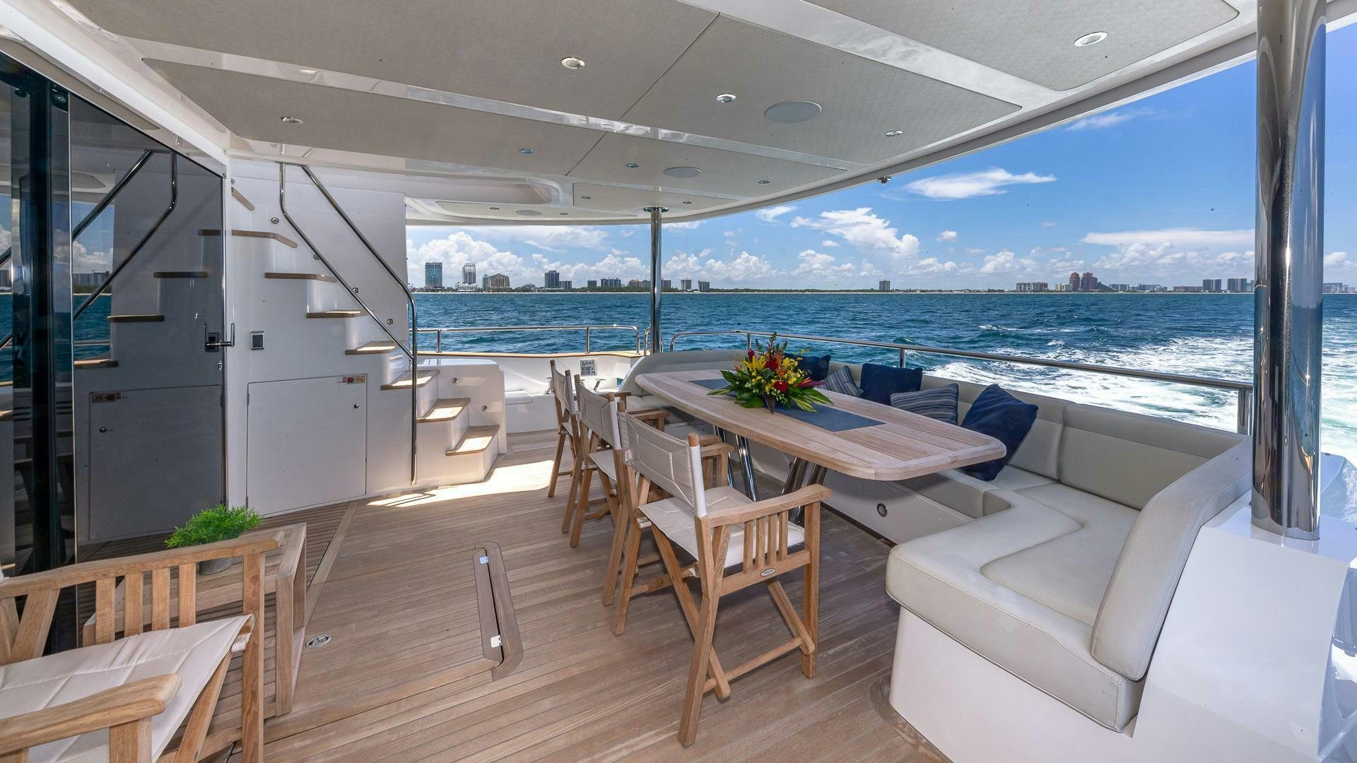 a room with a table and chairs aboard MIRRACLE Yacht for Sale
