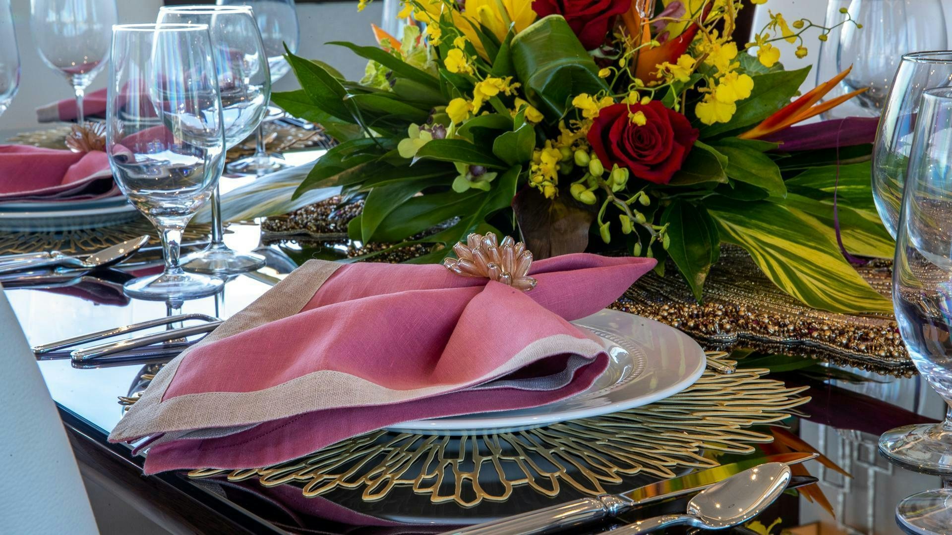 a table with a plate of food and glasses on it aboard MIRRACLE Yacht for Sale