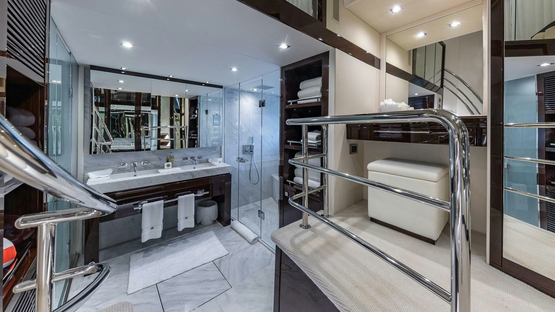 a large bathroom with a large glass shower unit aboard MIRRACLE Yacht for Sale