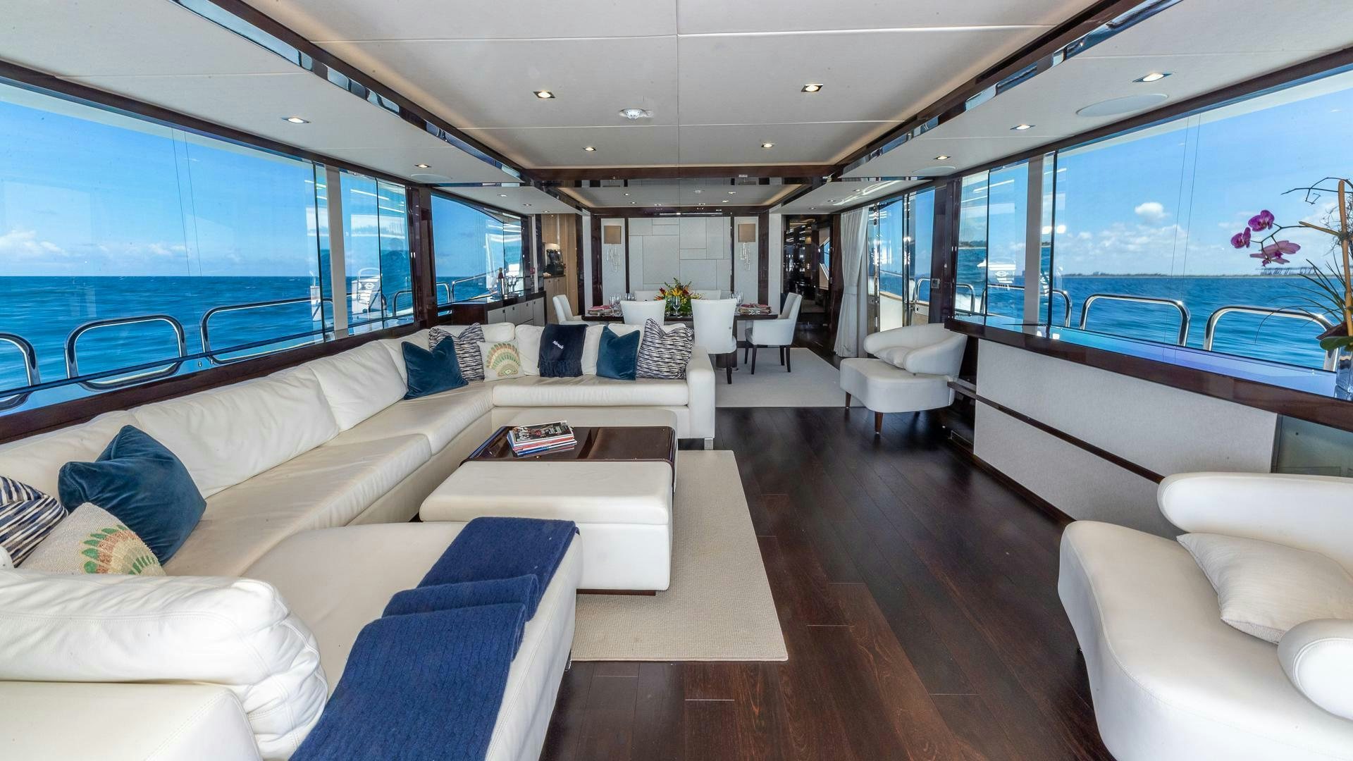 a living room with a large window aboard MIRRACLE Yacht for Sale