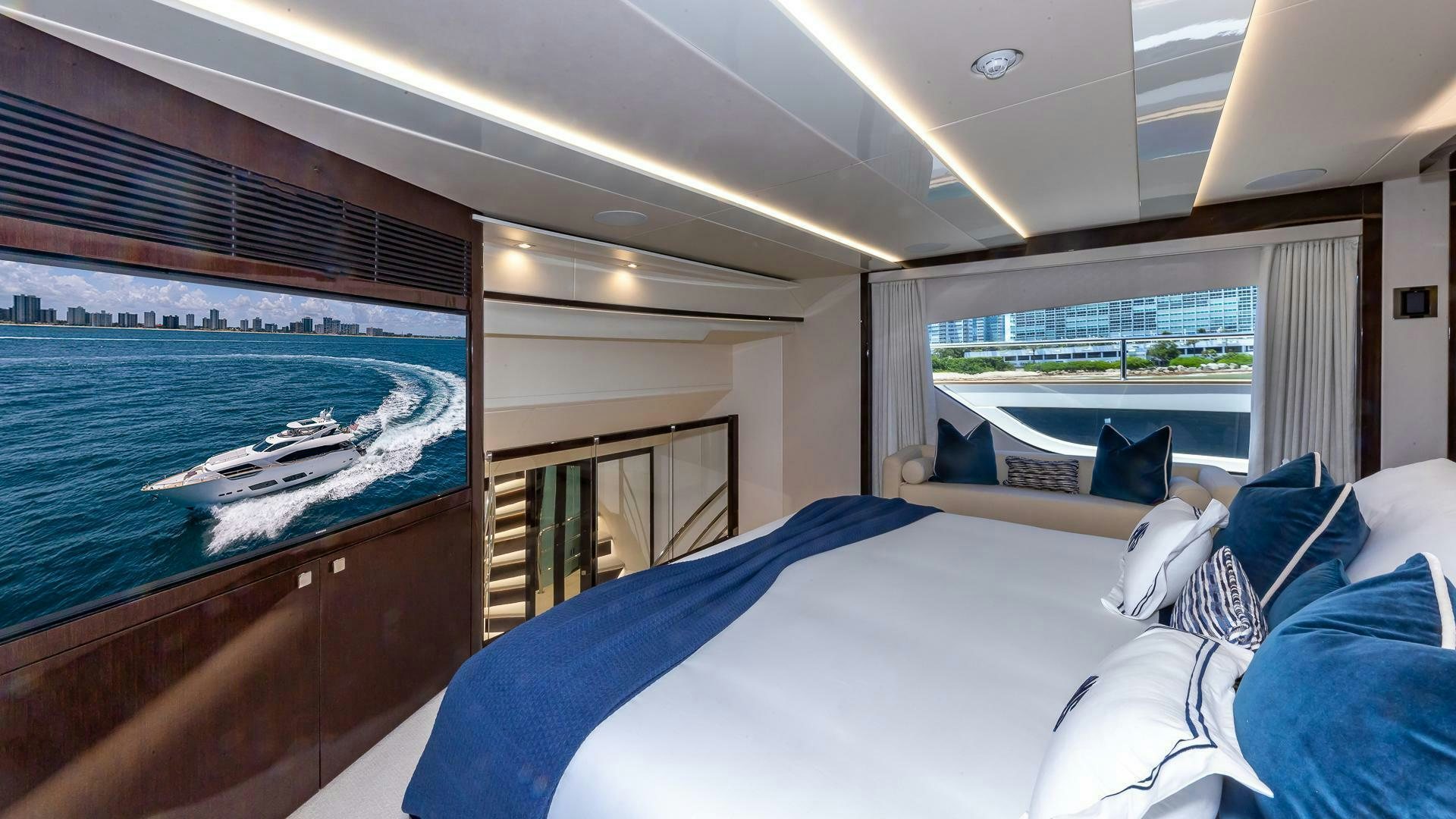 a room with a bed and a large window aboard MIRRACLE Yacht for Sale