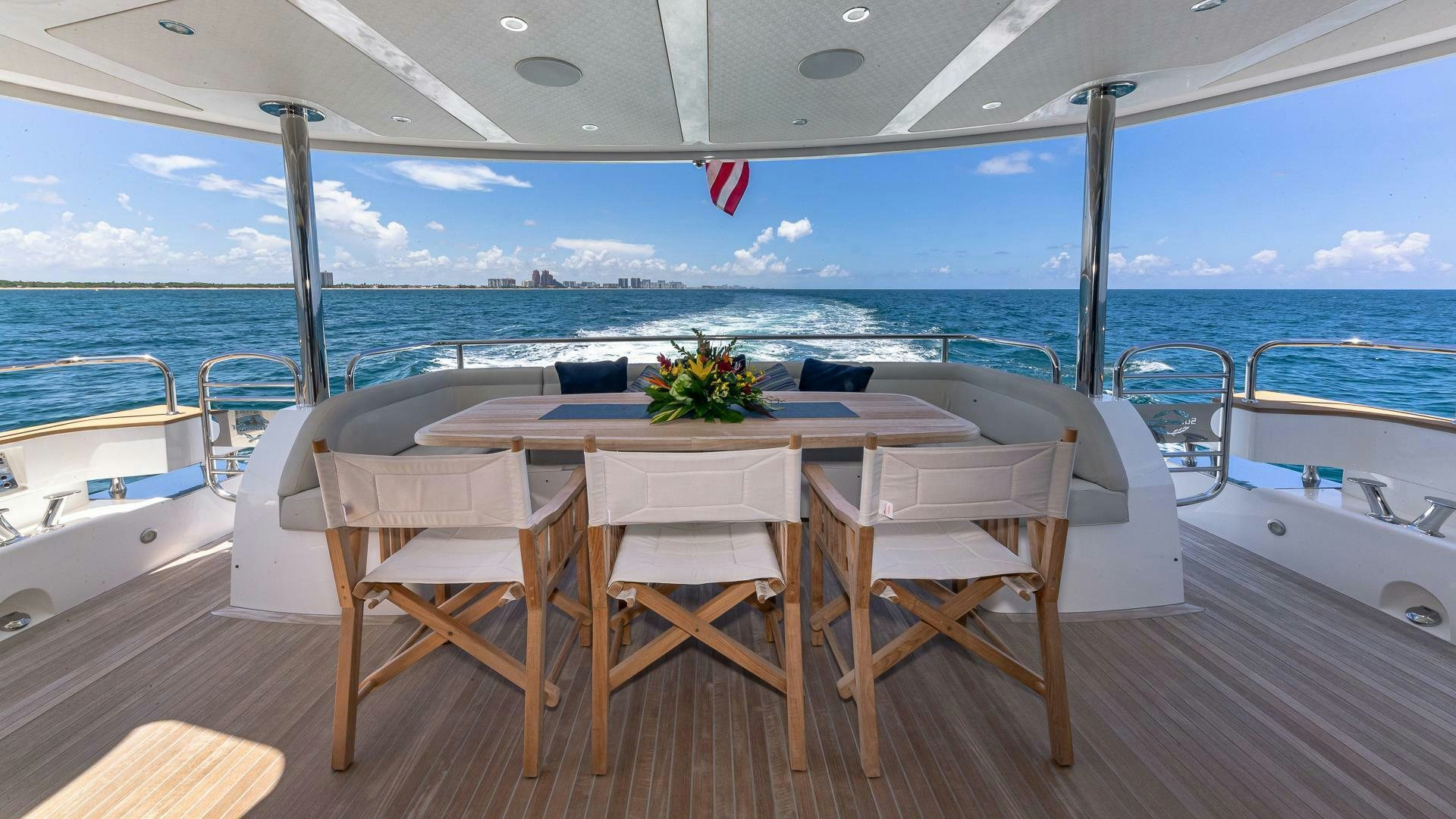 a table on a deck overlooking the ocean aboard MIRRACLE Yacht for Sale