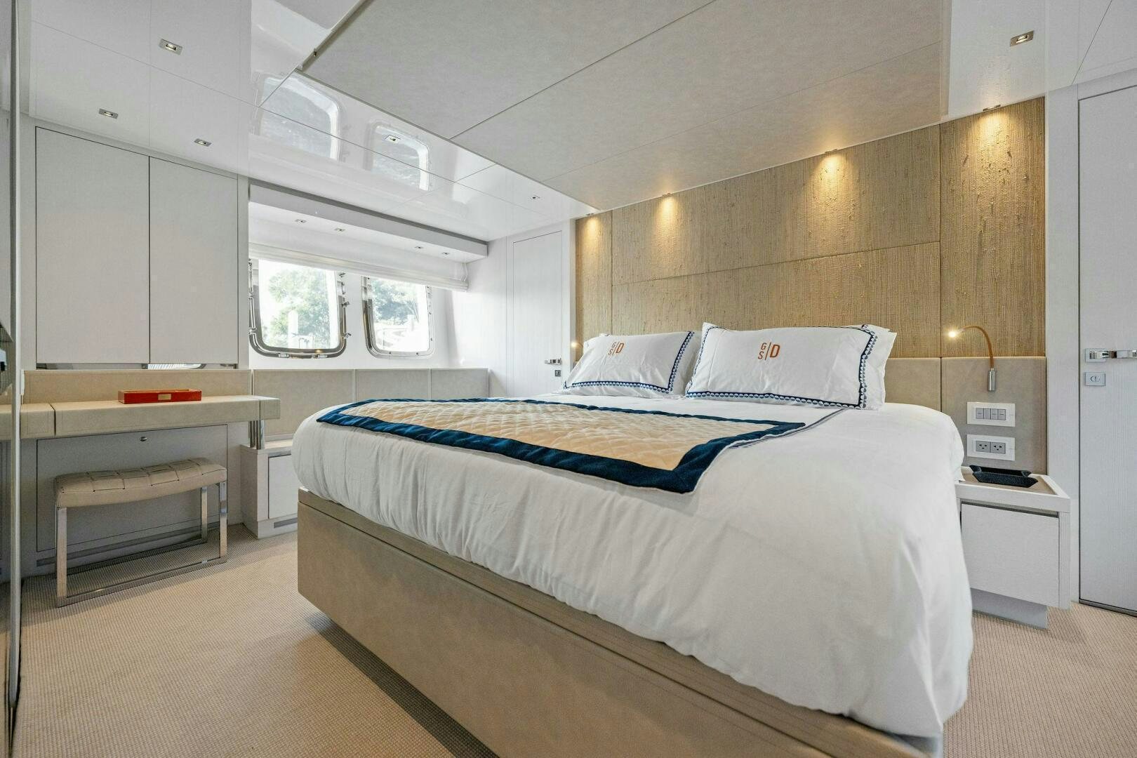 a bedroom with a bed and desk aboard SORI SAN LORENZO Yacht for Sale