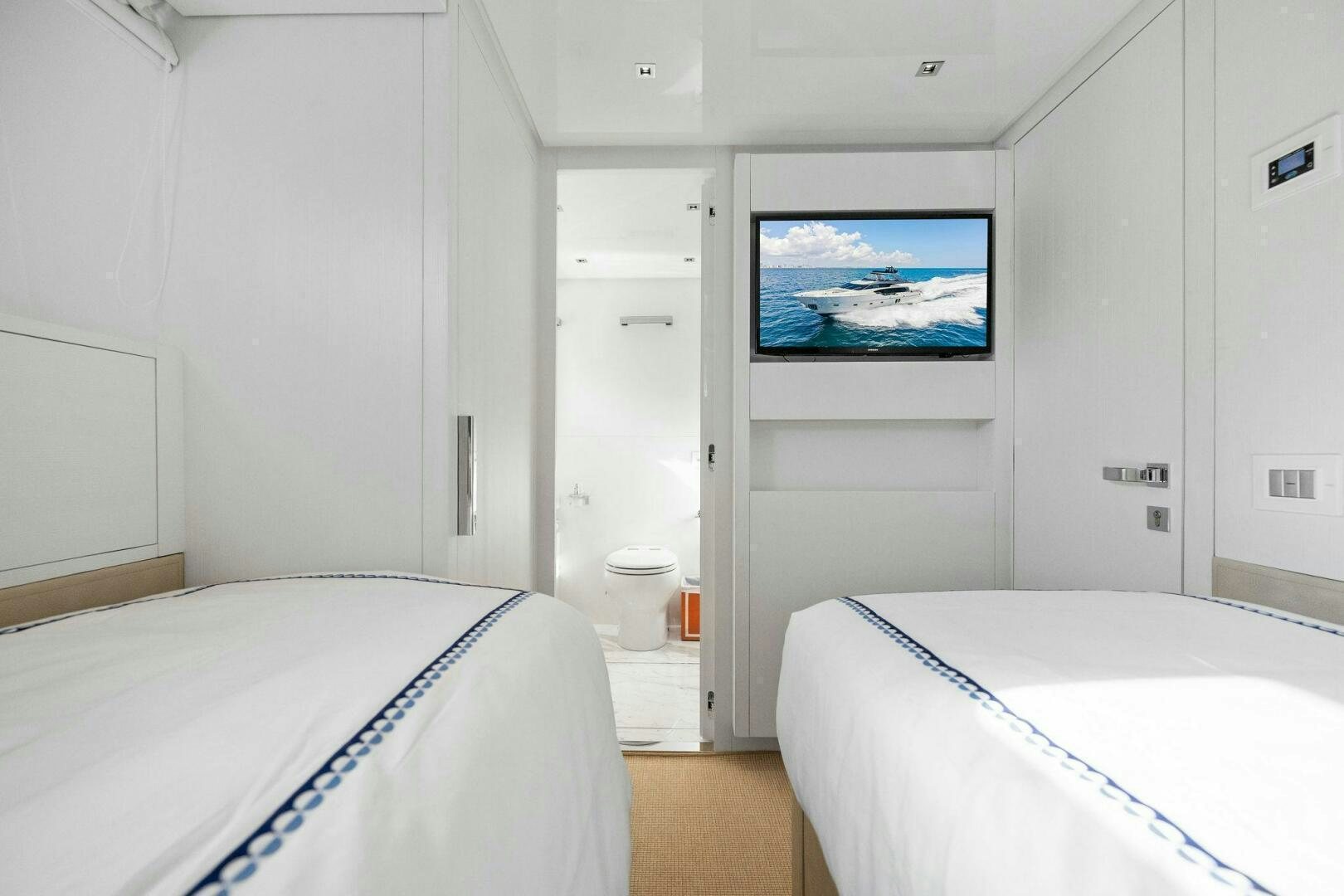 a bedroom with a tv on the wall aboard SORI SAN LORENZO Yacht for Sale
