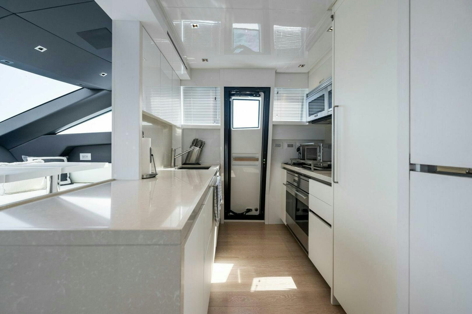 a kitchen with white cabinets aboard SORI SAN LORENZO Yacht for Sale