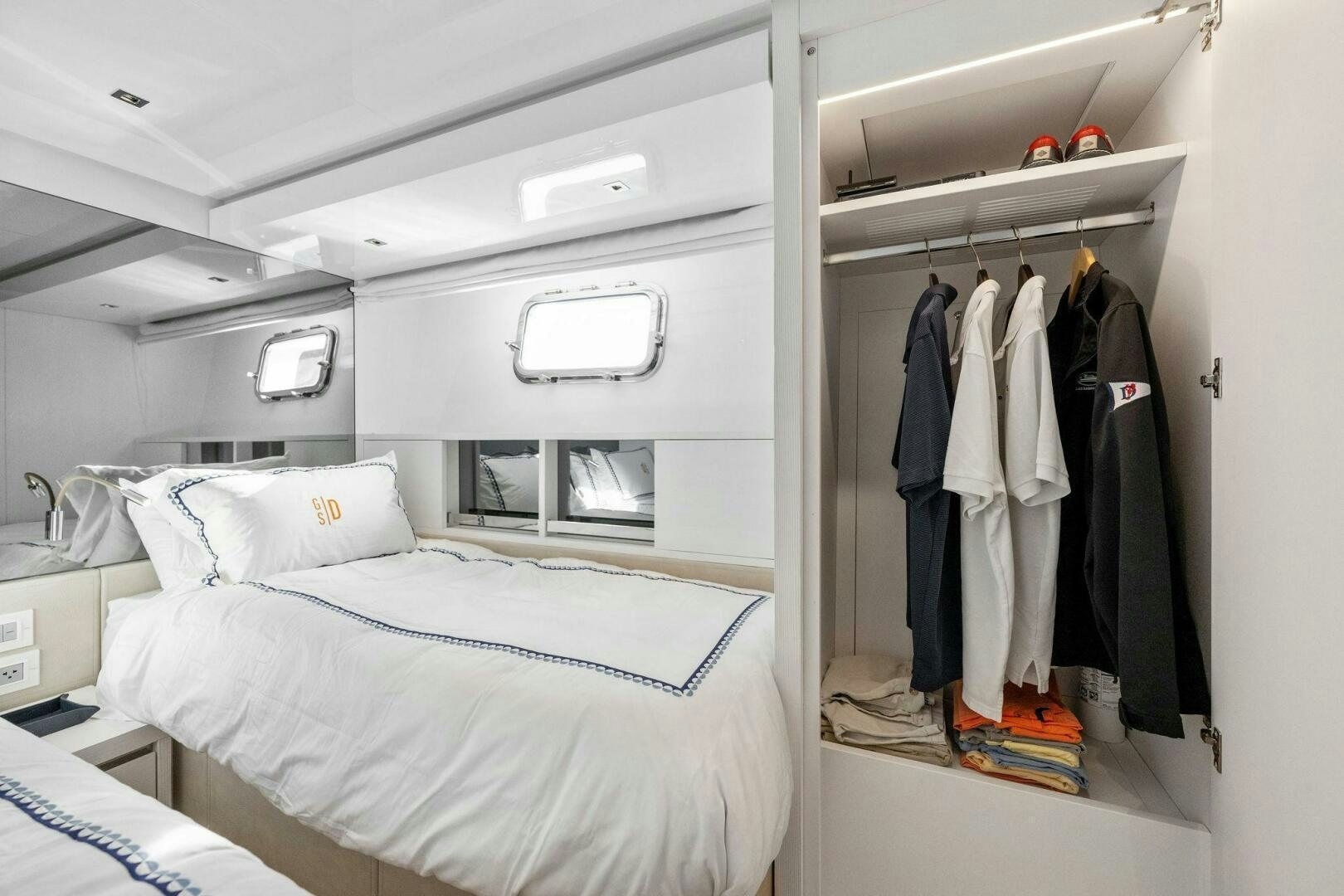 a closet with clothes on the wall aboard SORI SAN LORENZO Yacht for Sale