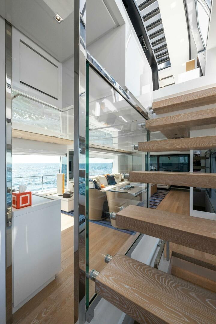 a room with a glass wall and a table and chairs aboard SORI SAN LORENZO Yacht for Sale
