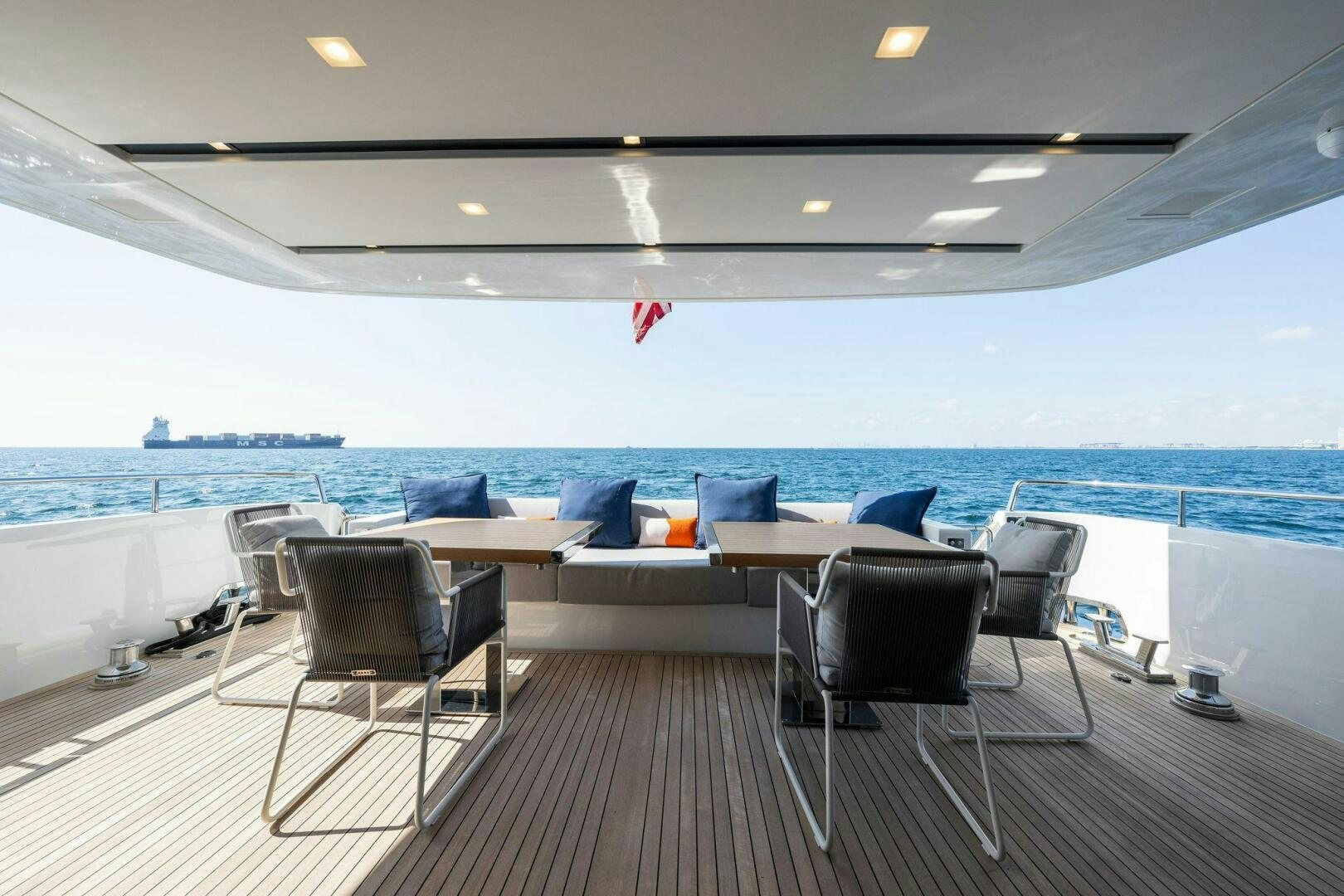 a room with a table chairs and a large body of water aboard SORI SAN LORENZO Yacht for Sale