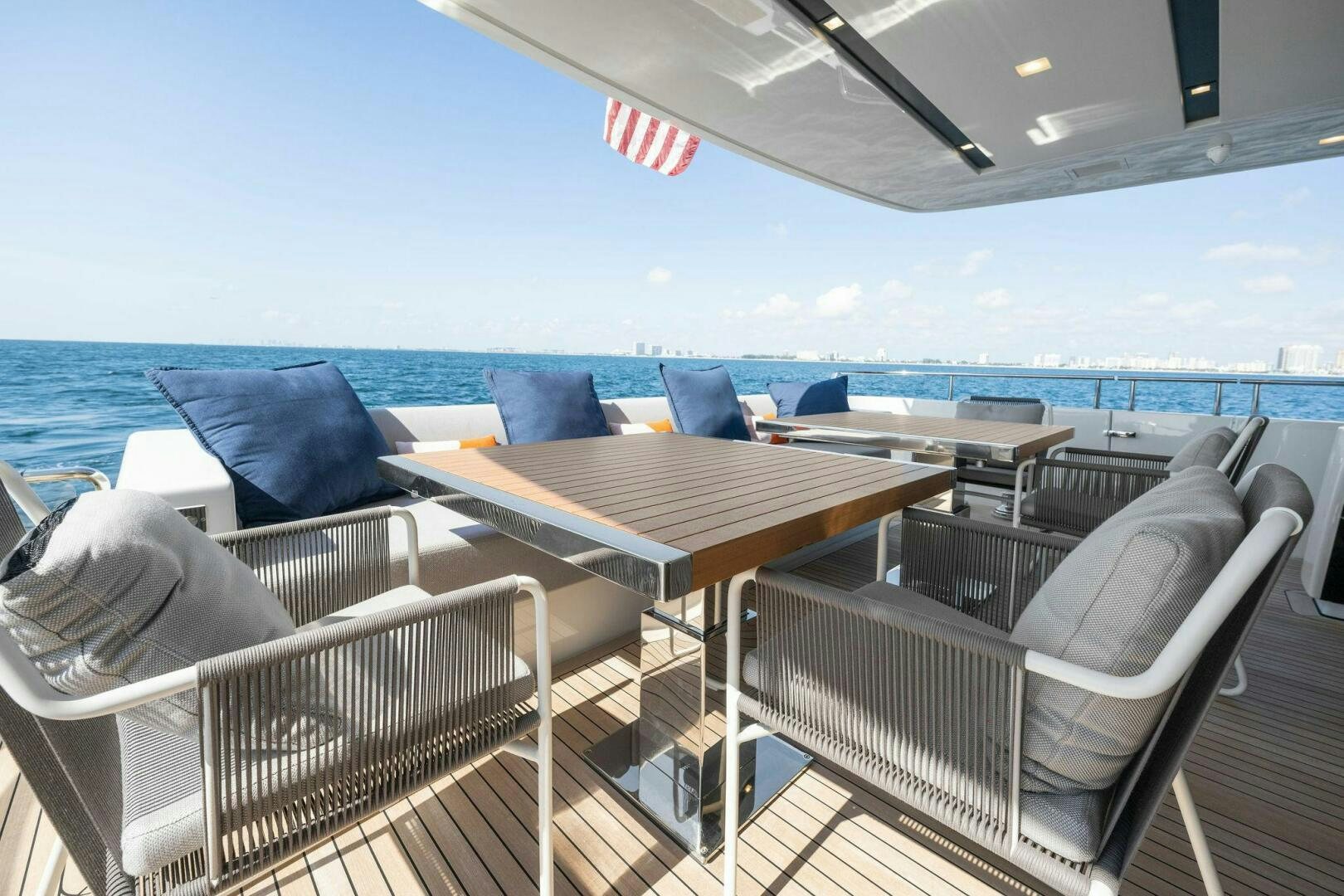 a deck with chairs and tables aboard SORI SAN LORENZO Yacht for Sale