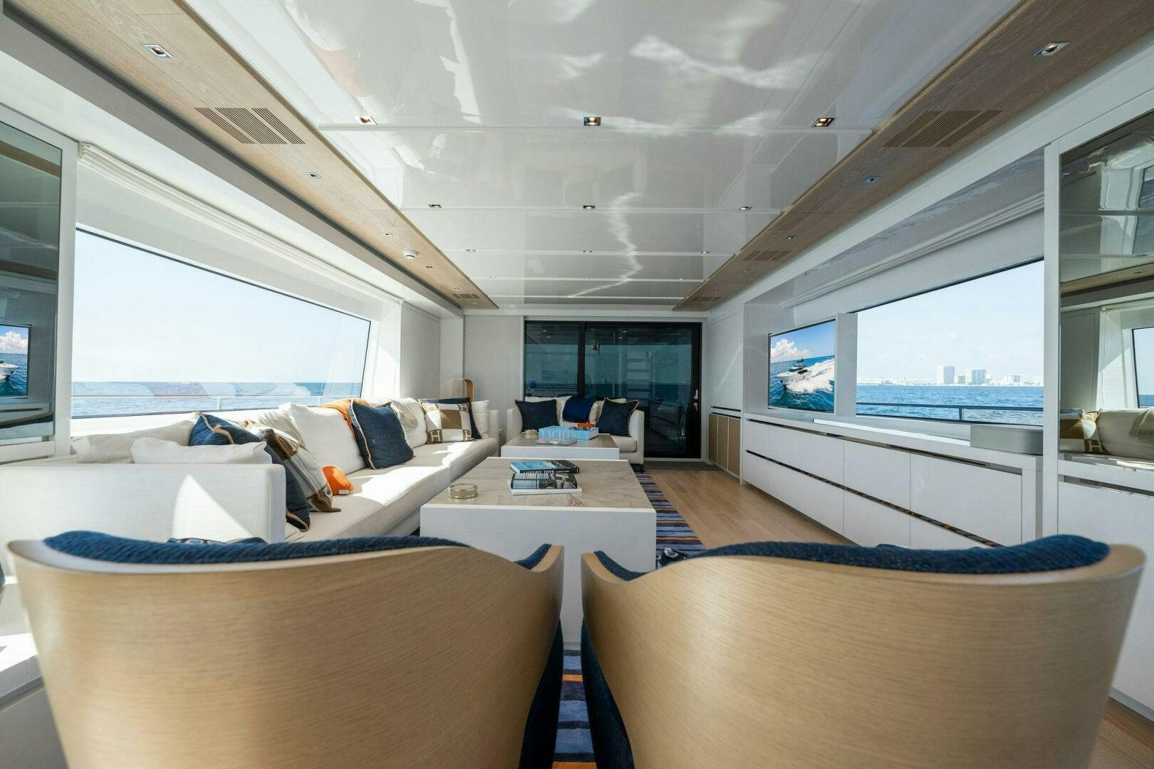 a living room with couches and a table aboard SORI SAN LORENZO Yacht for Sale
