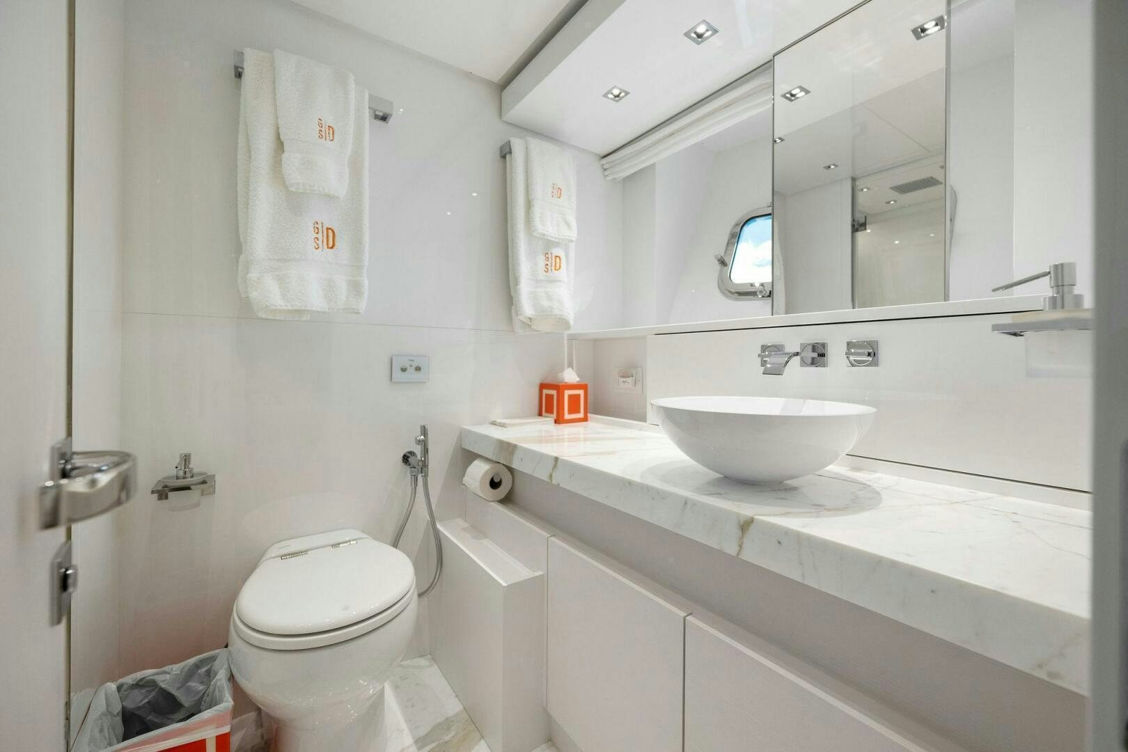a bathroom with a sink toilet and a mirror aboard SORI SAN LORENZO Yacht for Sale