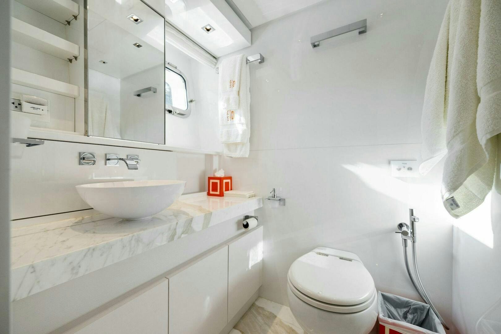 a bathroom with a sink toilet and a mirror aboard SORI SAN LORENZO Yacht for Sale