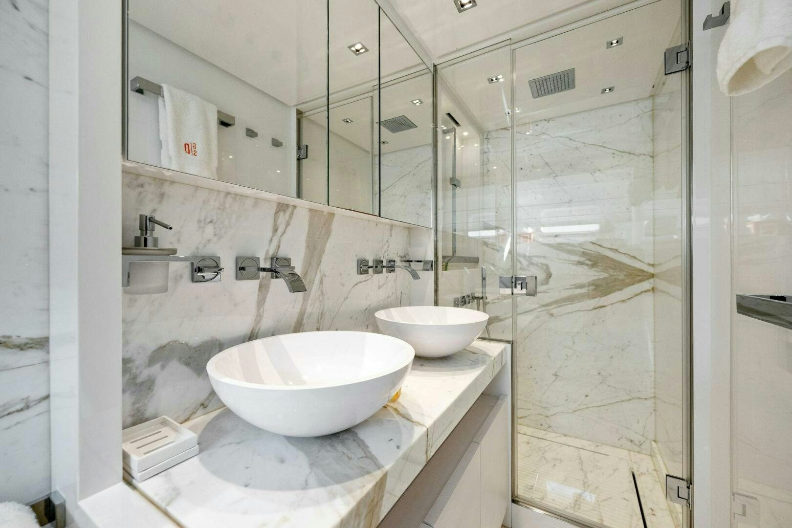 a bathroom with a sink and a mirror aboard SORI SAN LORENZO Yacht for Sale