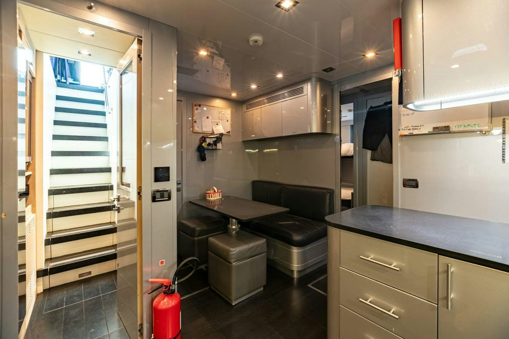 a room with a desk and a bed aboard 1K Yacht for Sale