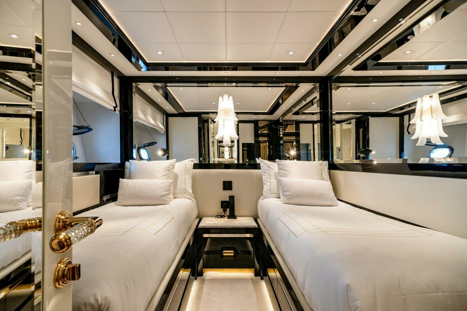 a room with white beds aboard 1K Yacht for Sale