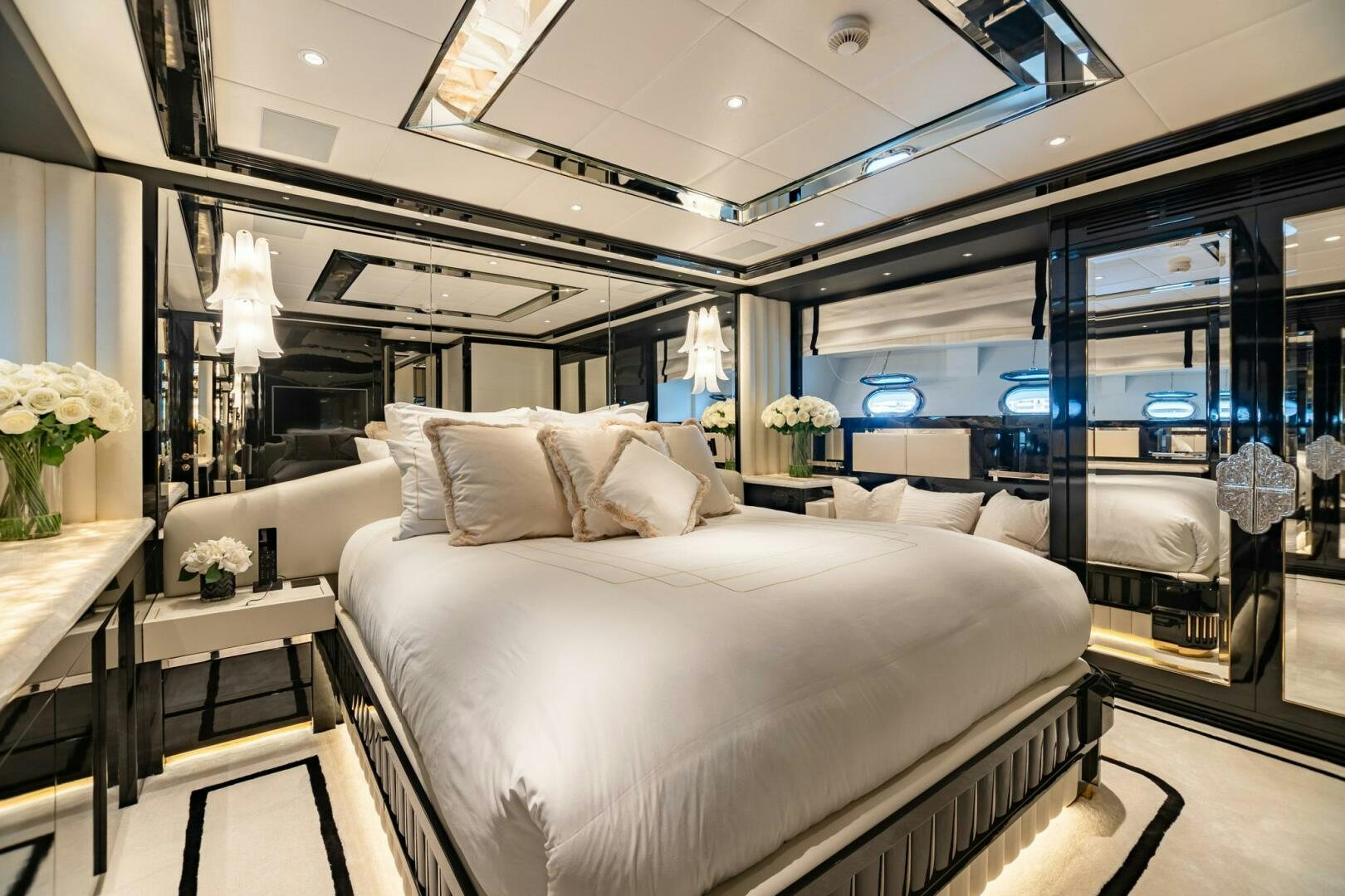 a room with a bed and a large mirror aboard 1K Yacht for Sale
