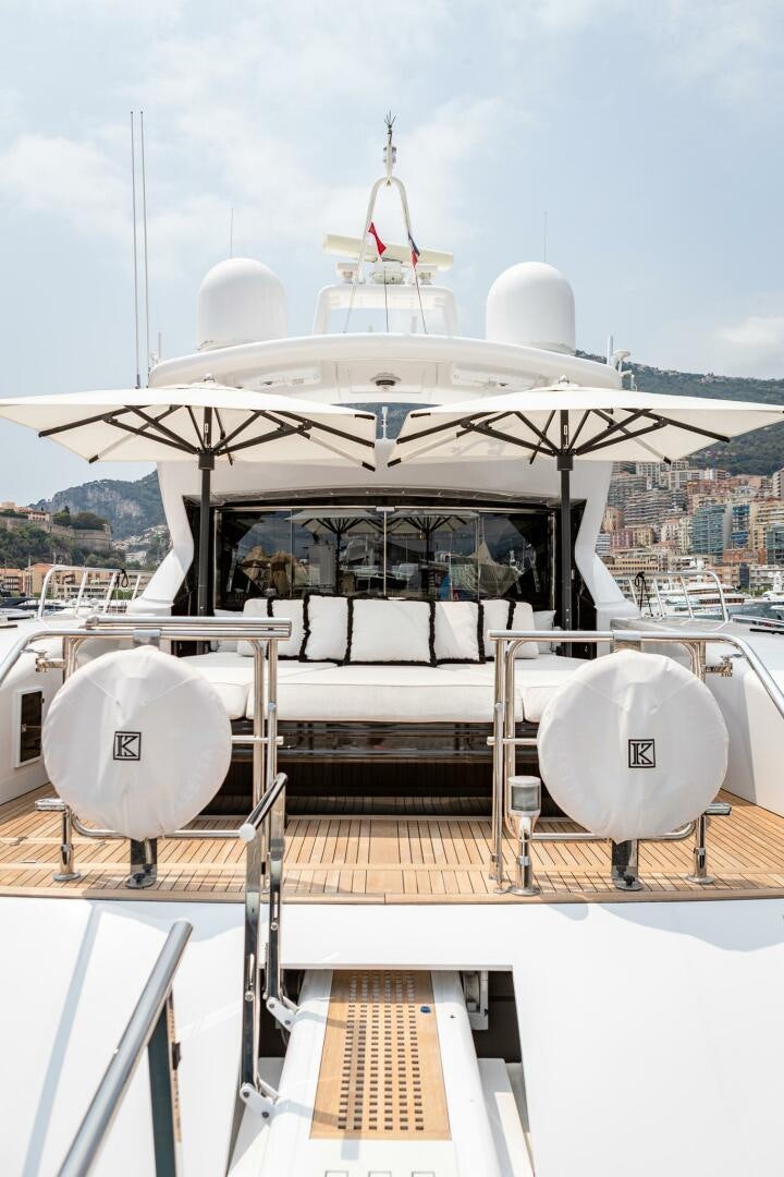 a large white boat on a deck aboard 1K Yacht for Sale