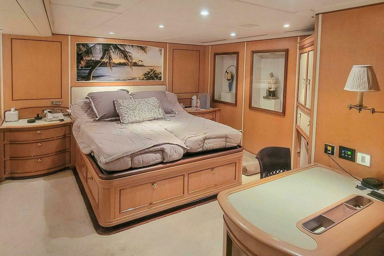 a bedroom with a bed and desk aboard MITSEAAH Yacht for Sale