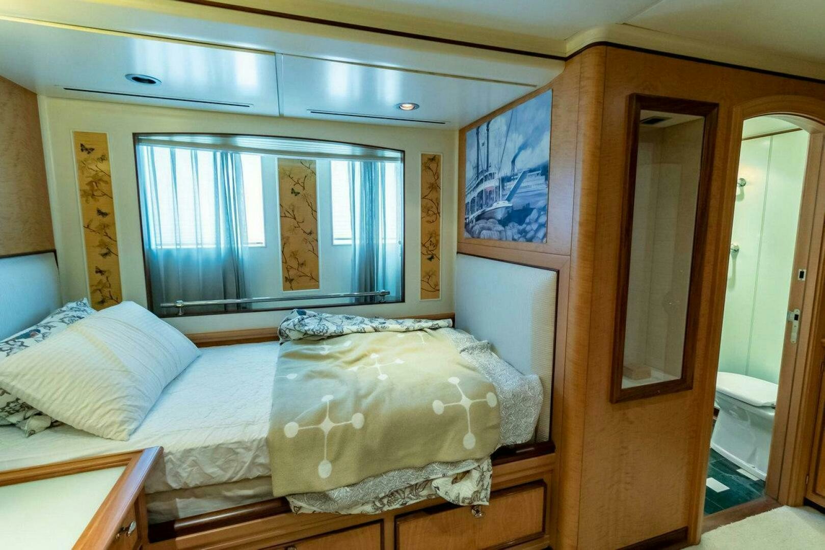 a bed with a painting on the wall aboard MITSEAAH Yacht for Sale