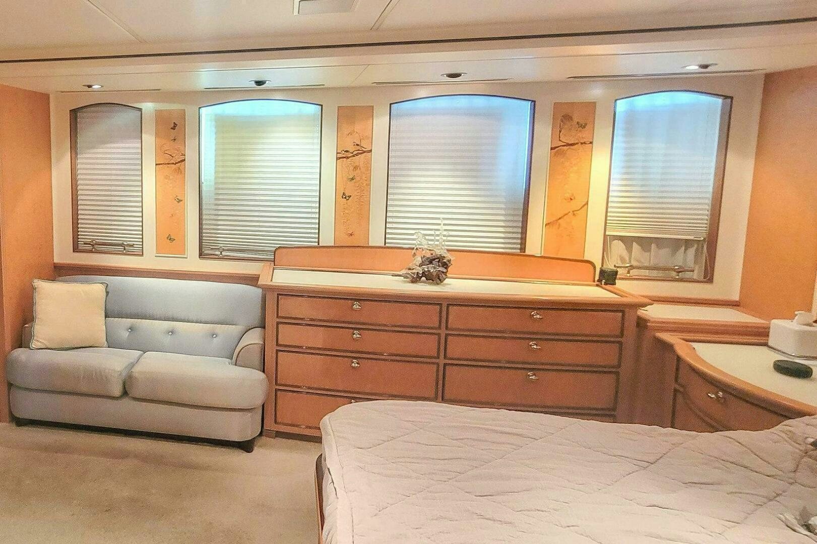 a bedroom with a bed and a couch aboard MITSEAAH Yacht for Sale