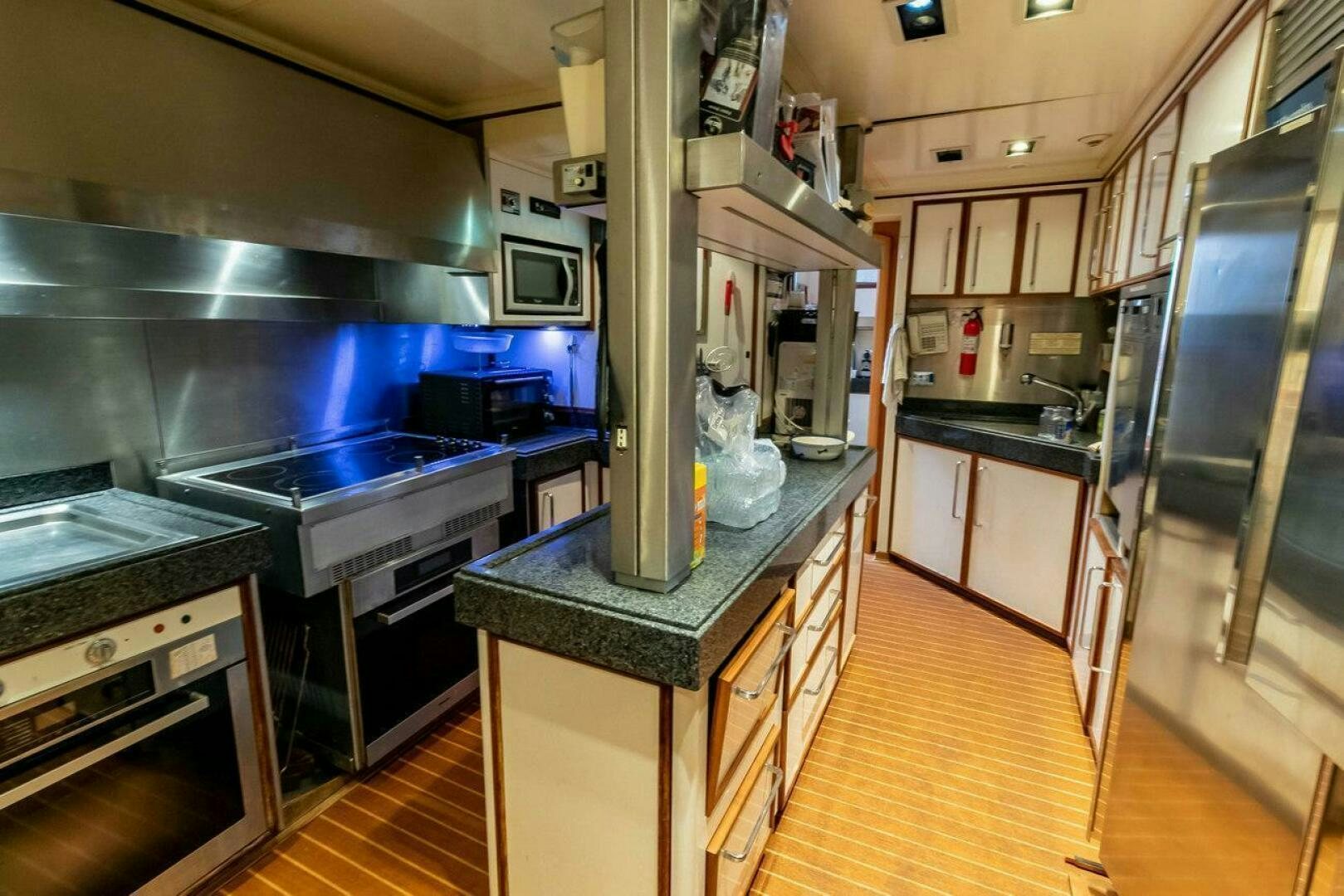 a kitchen with a large stainless steel stove and a counter top aboard MITSEAAH Yacht for Sale