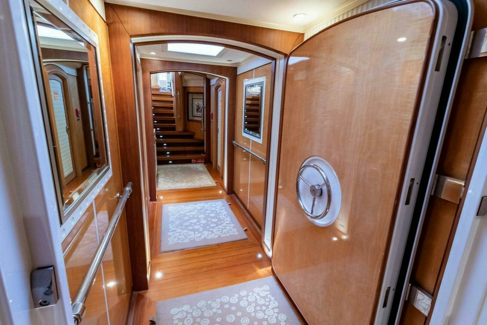 a hallway with a wood door aboard MITSEAAH Yacht for Sale