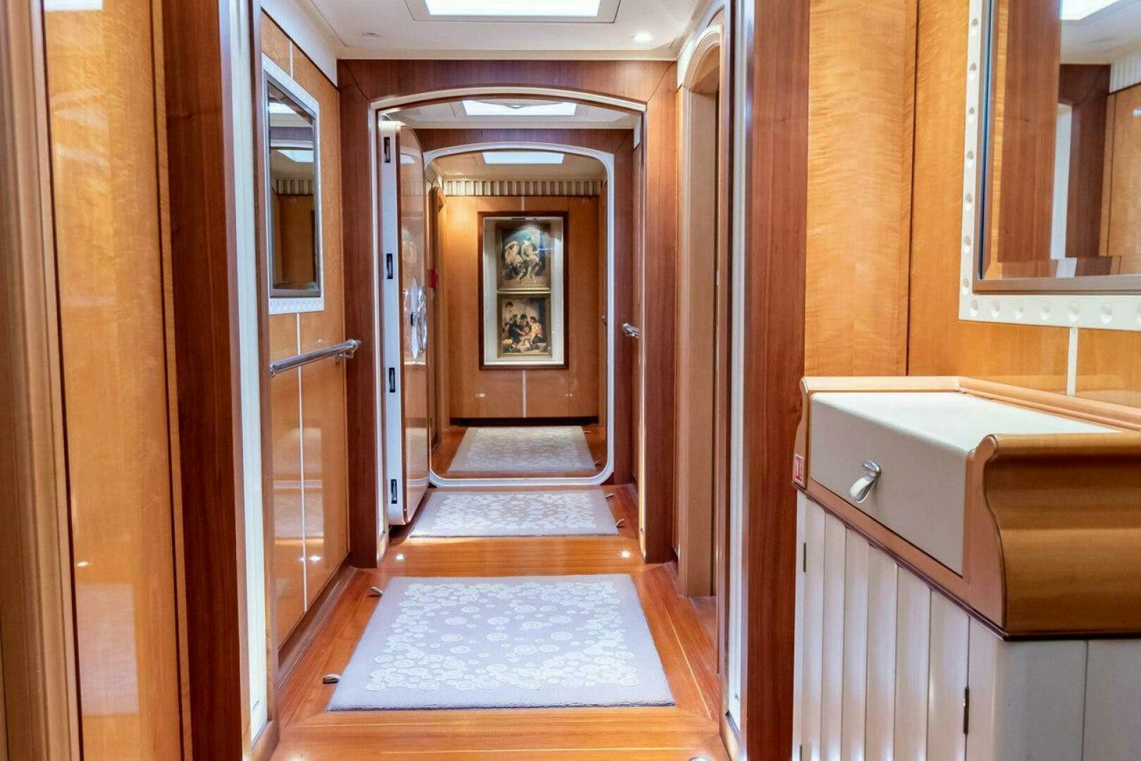 a hallway with a door and a rug on the floor aboard MITSEAAH Yacht for Sale