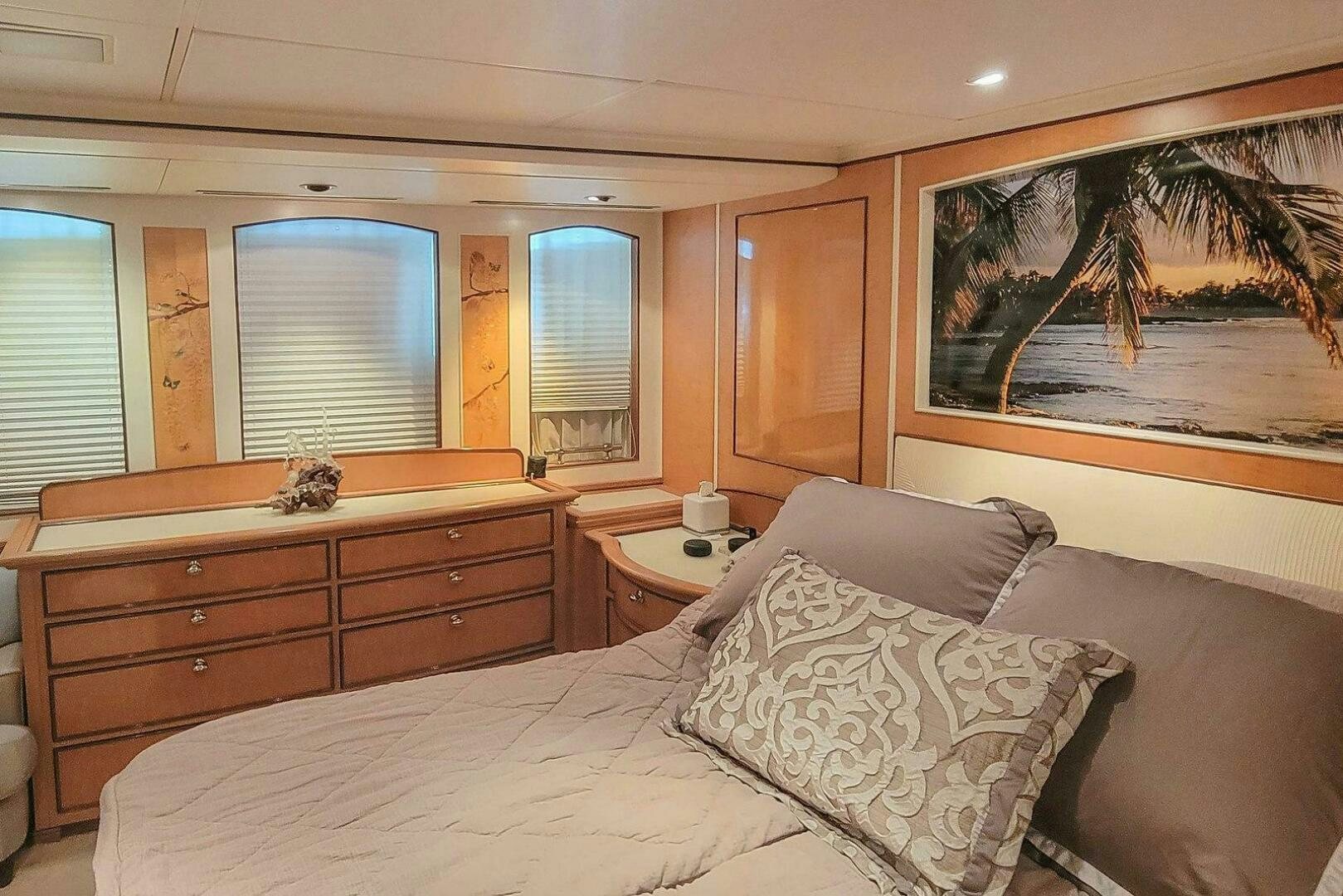 a bedroom with a bed and a dresser aboard MITSEAAH Yacht for Sale