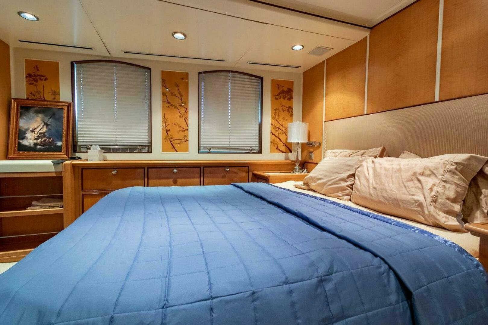 a bed with blue sheets aboard MITSEAAH Yacht for Sale