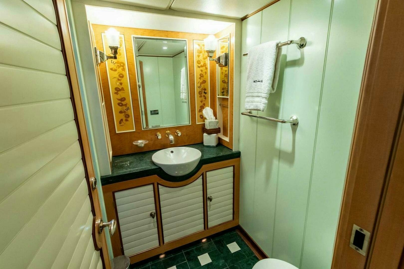 a bathroom with a sink and mirror aboard MITSEAAH Yacht for Sale