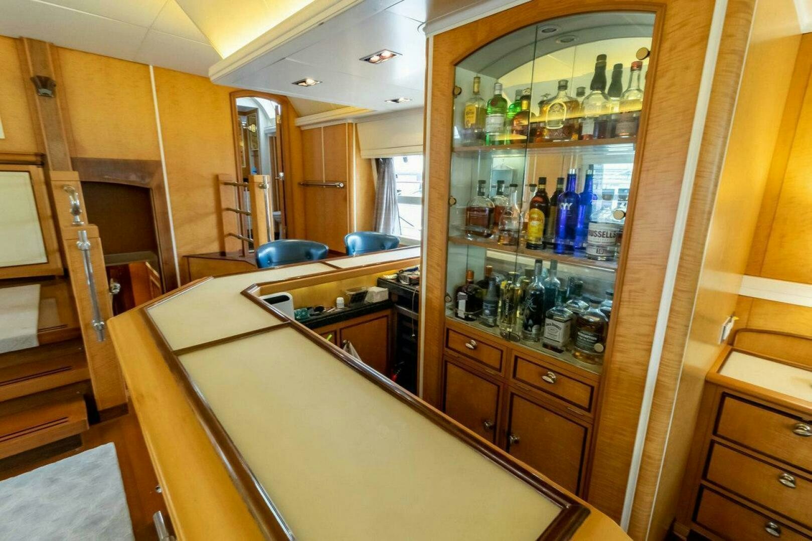 a glass cabinet with bottles on it aboard MITSEAAH Yacht for Sale