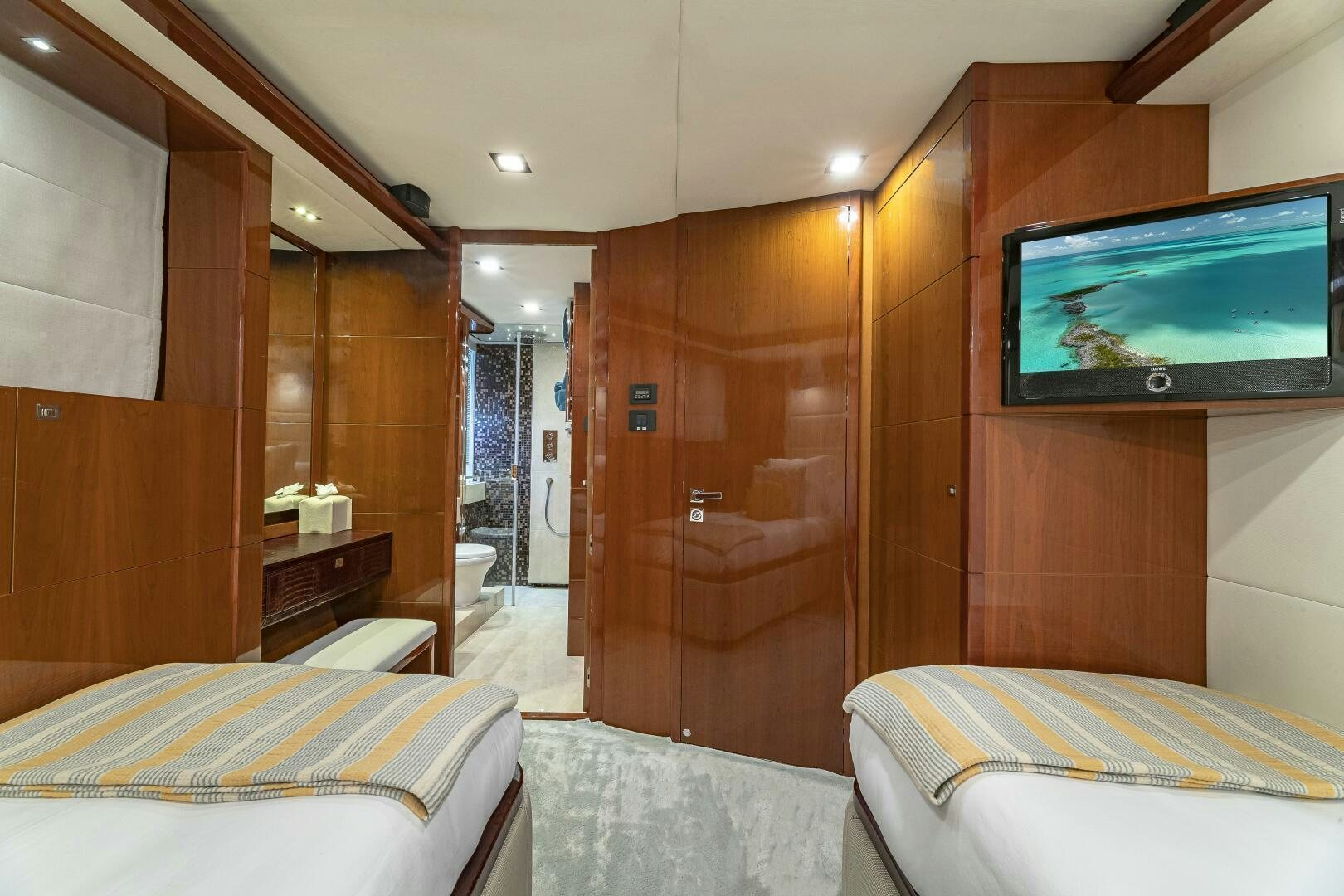 a bedroom with a bed and a tv aboard BEACHFRONT II Yacht for Sale