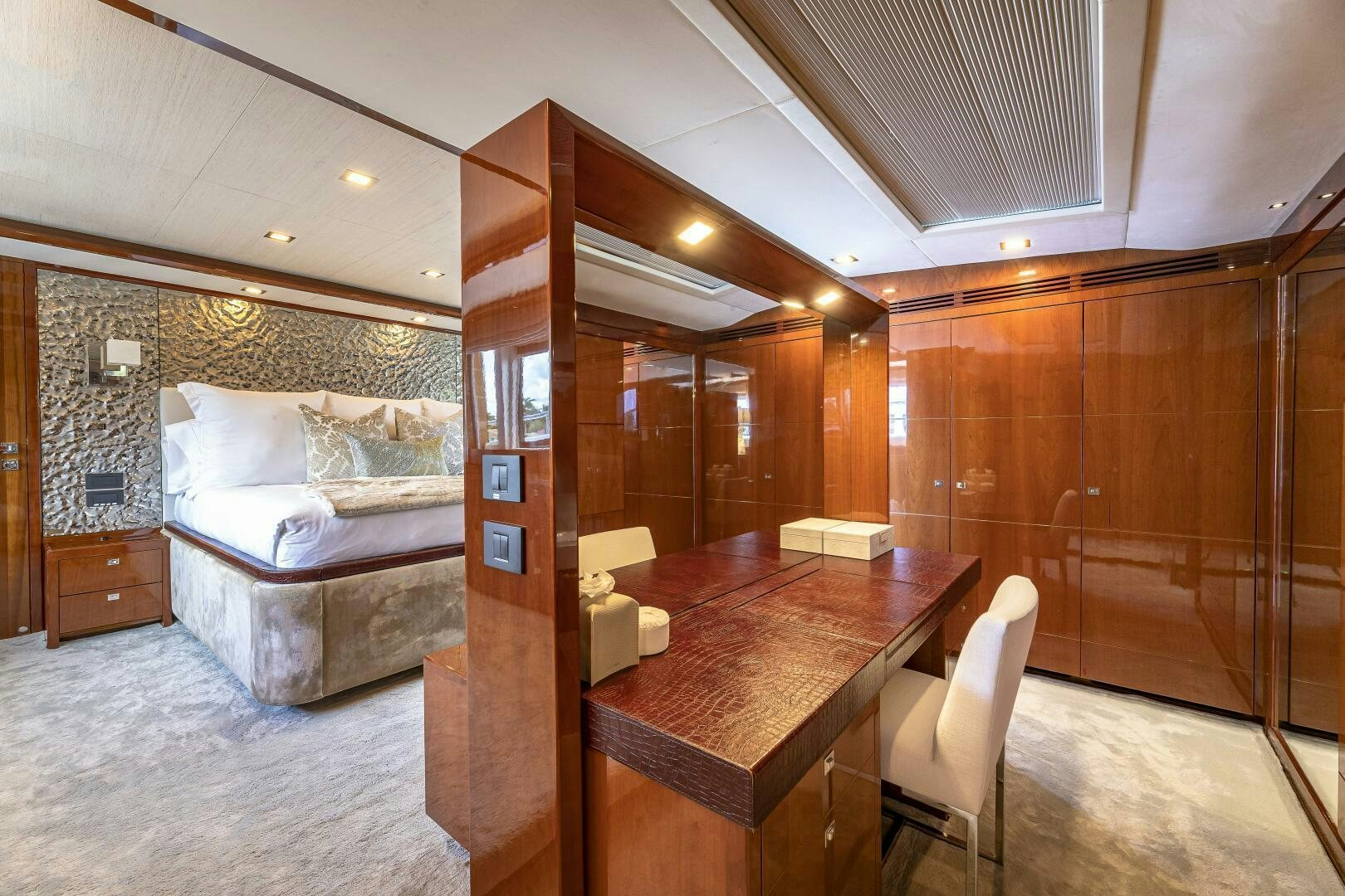 a bedroom with a bed and a desk aboard BEACHFRONT II Yacht for Sale