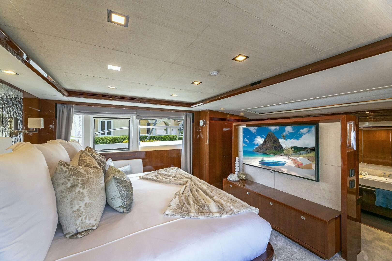 a bedroom with a large television aboard BEACHFRONT II Yacht for Sale