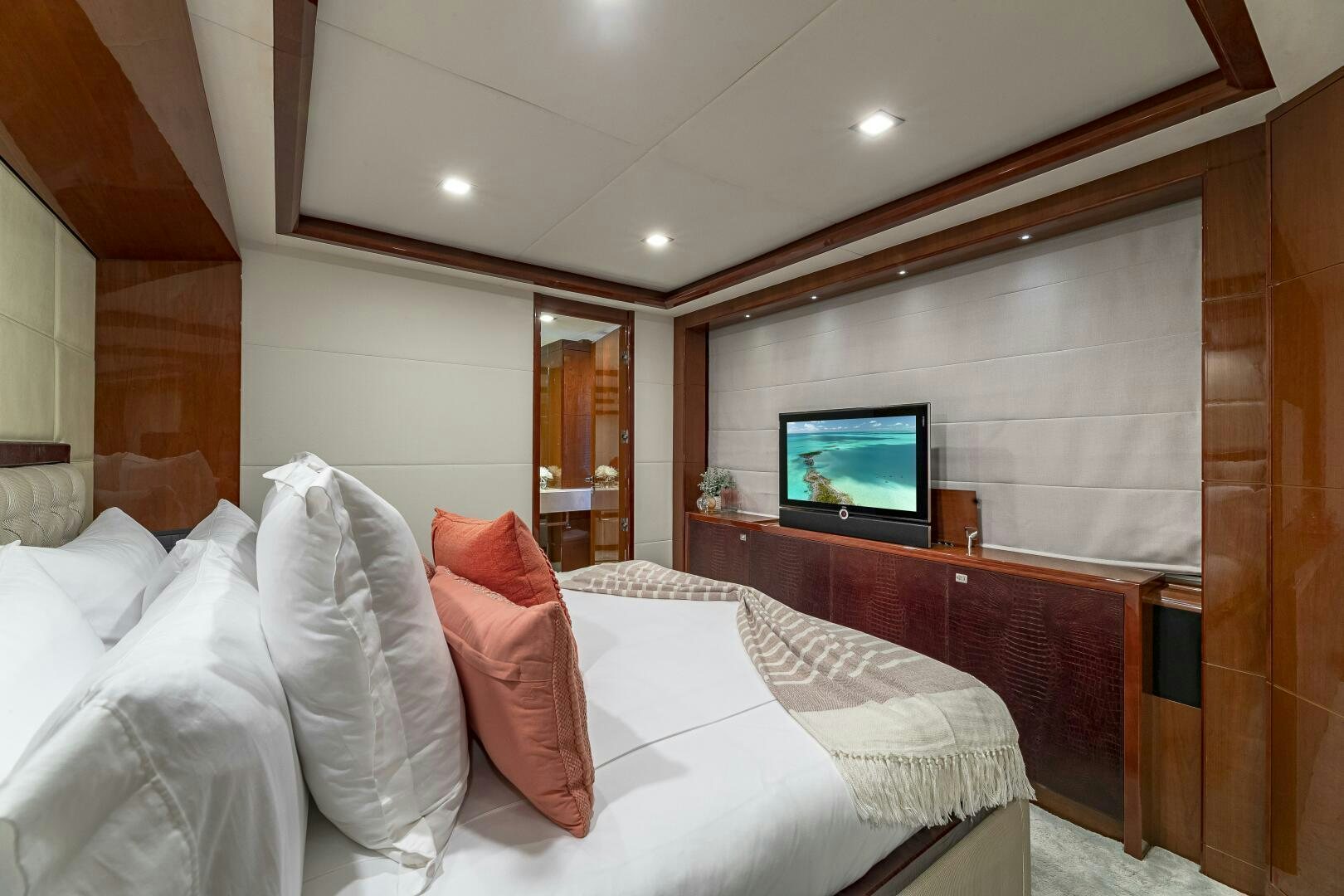 a room with a bed and a television aboard BEACHFRONT II Yacht for Sale
