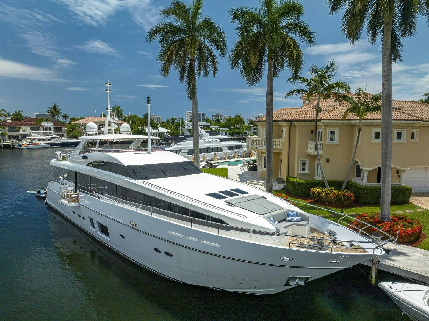 a white yacht docked in a tropical area aboard BEACHFRONT II Yacht for Sale