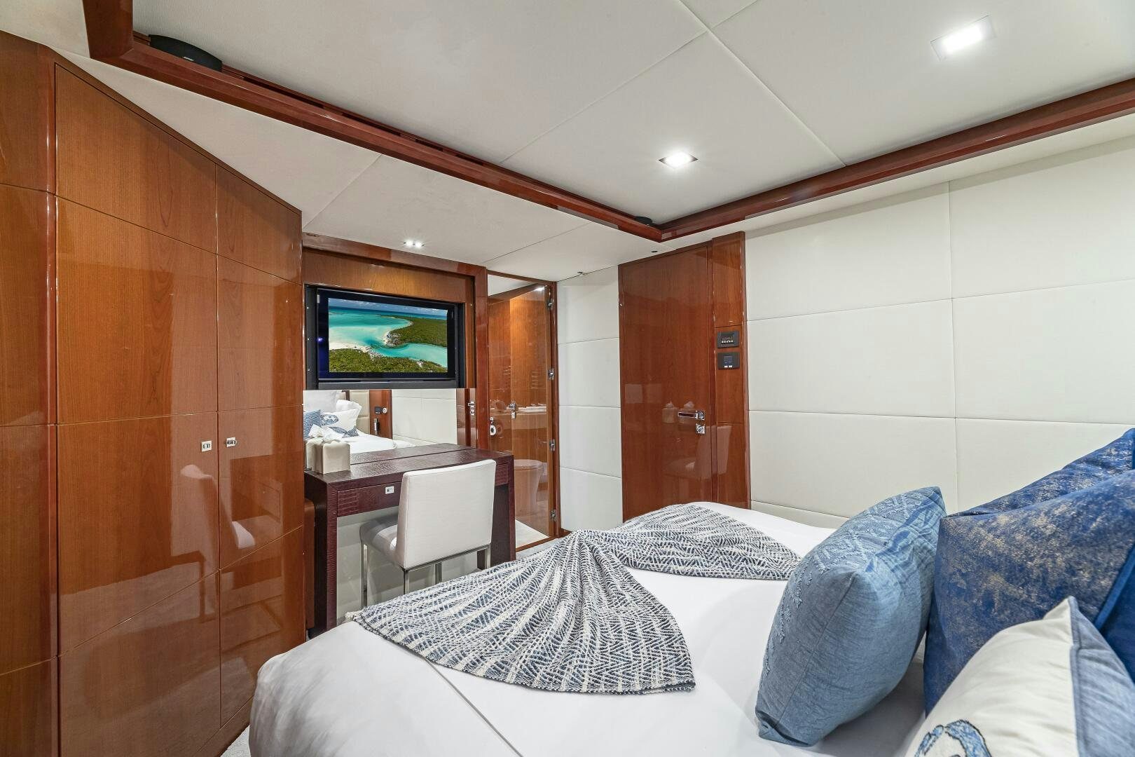 a bedroom with a bed and a television aboard BEACHFRONT II Yacht for Sale